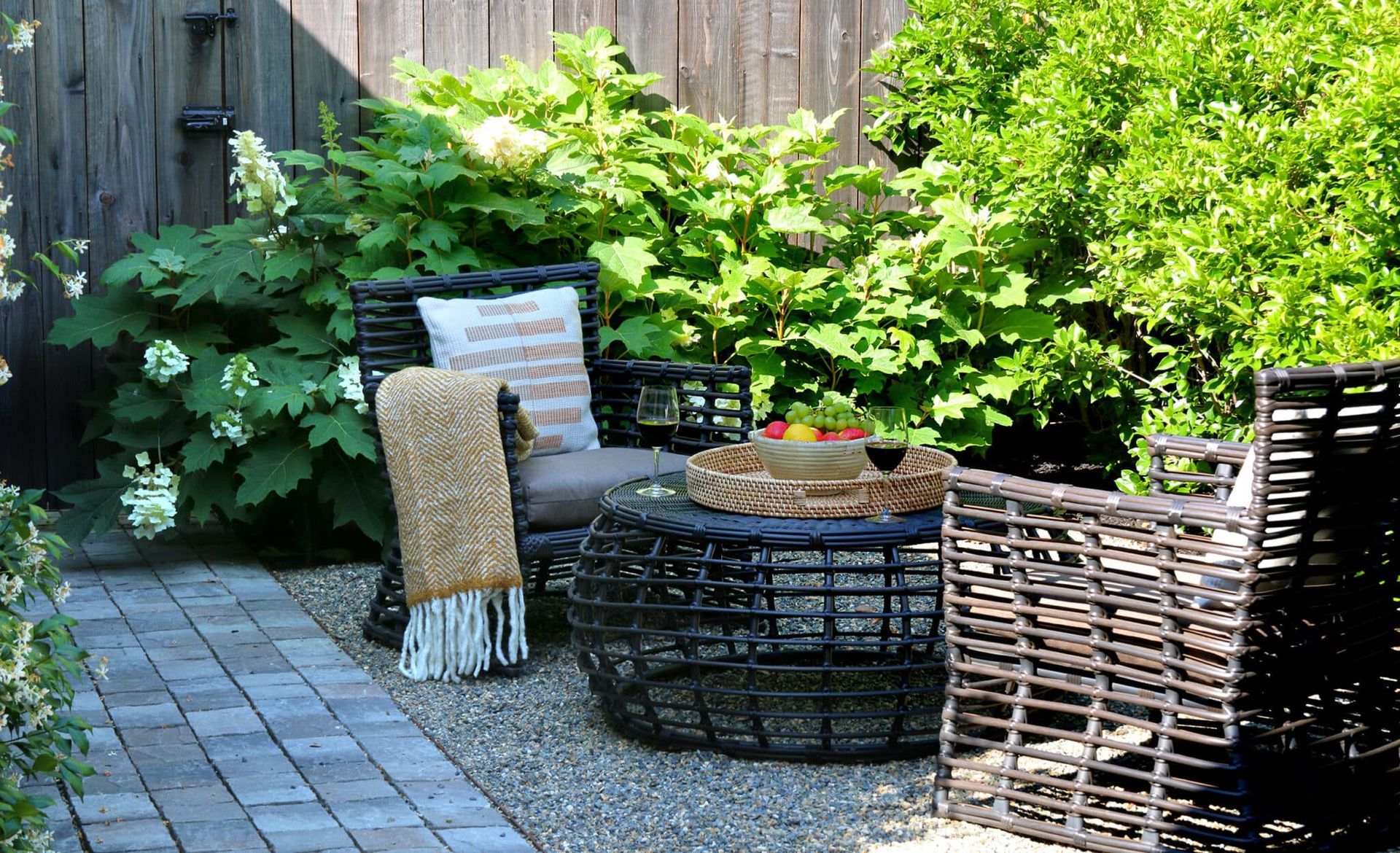 A patio with chairs , a table and a blanket on it.