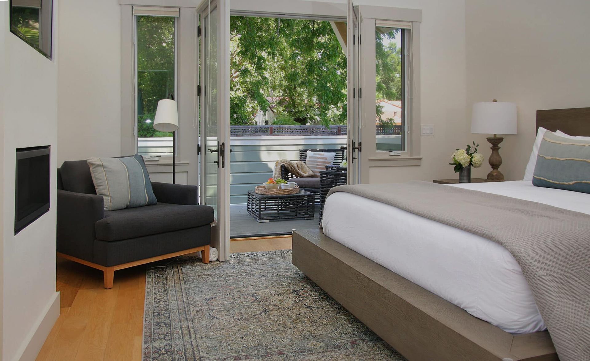 A bedroom with a king size bed and a chair