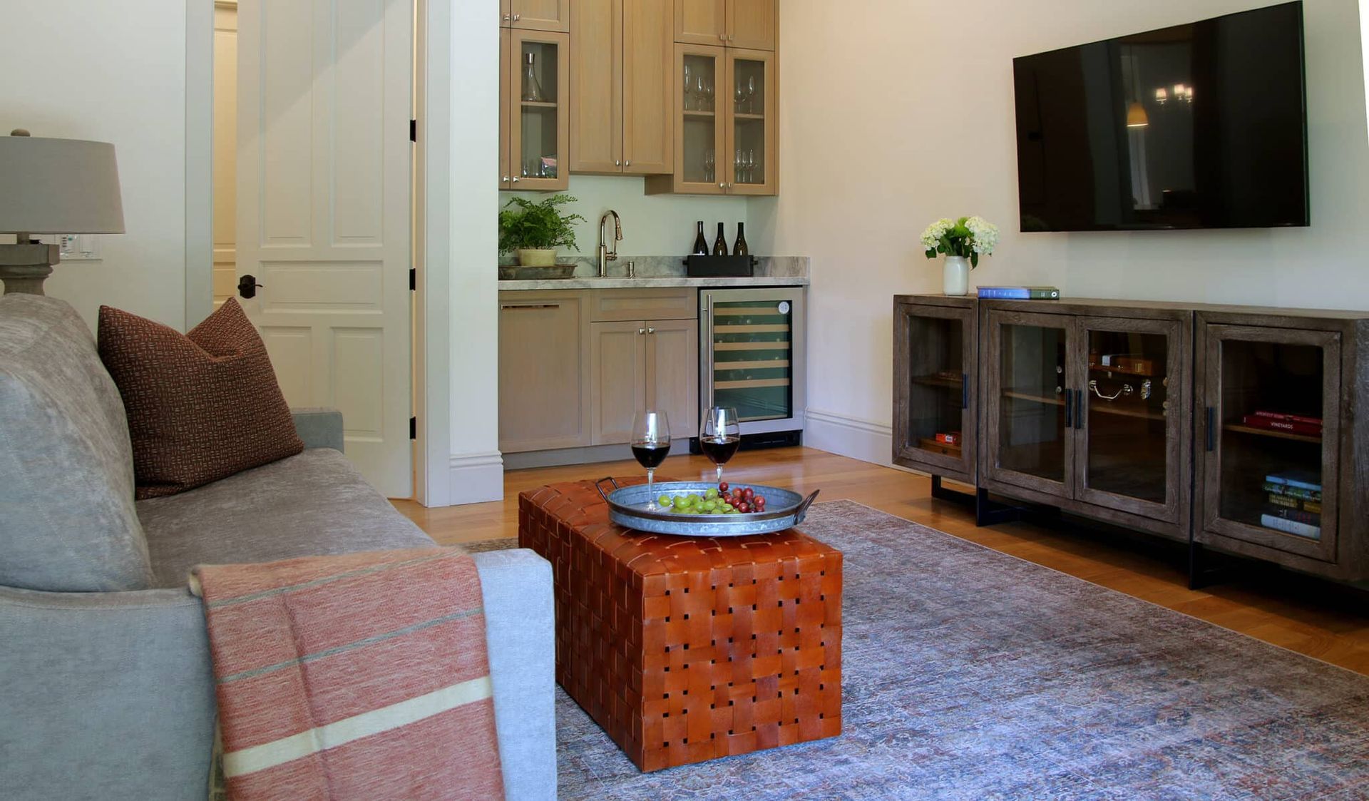 A living room with a couch , coffee table , and television.