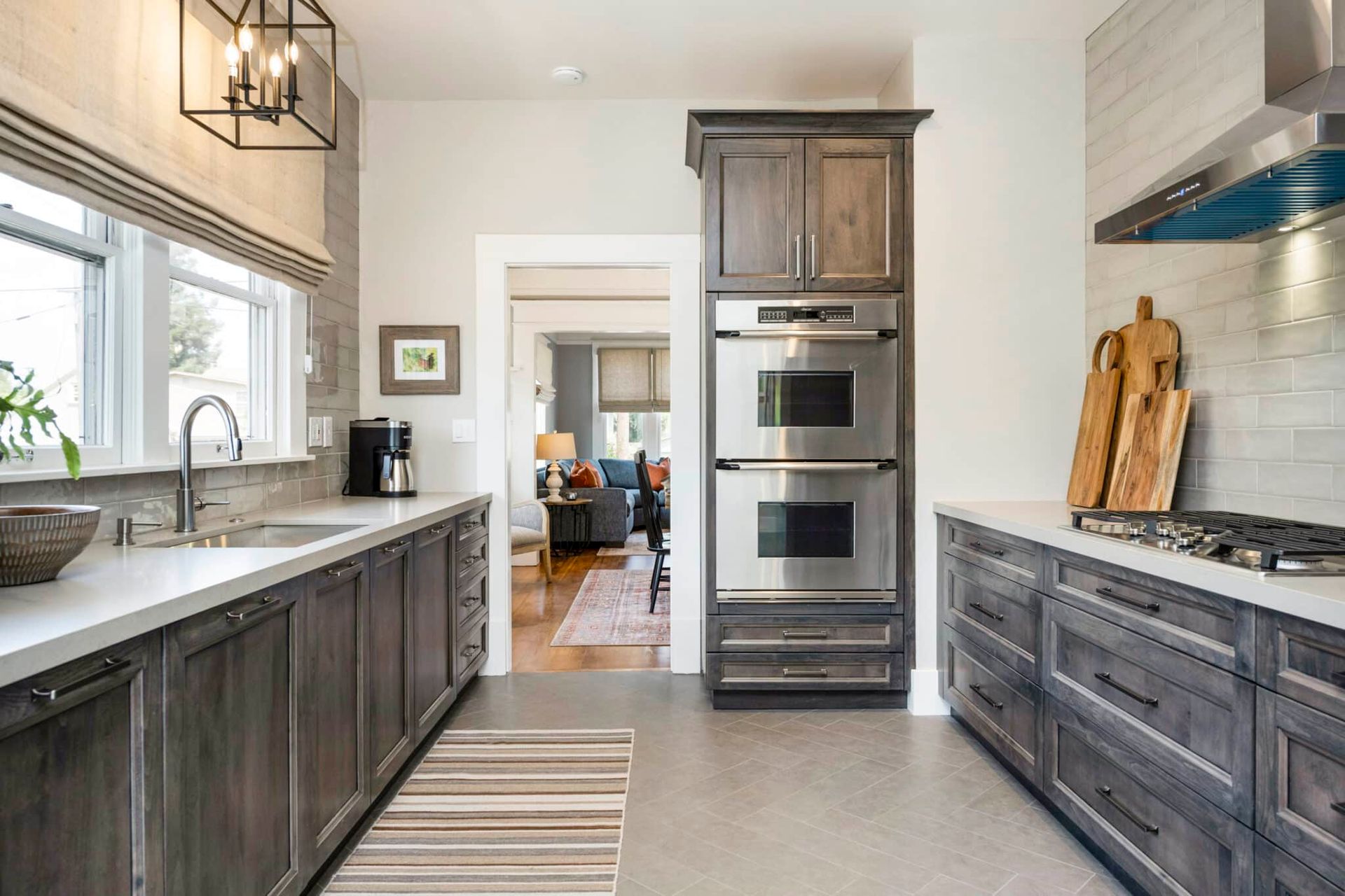 A kitchen with stainless steel appliances and wooden cabinets.