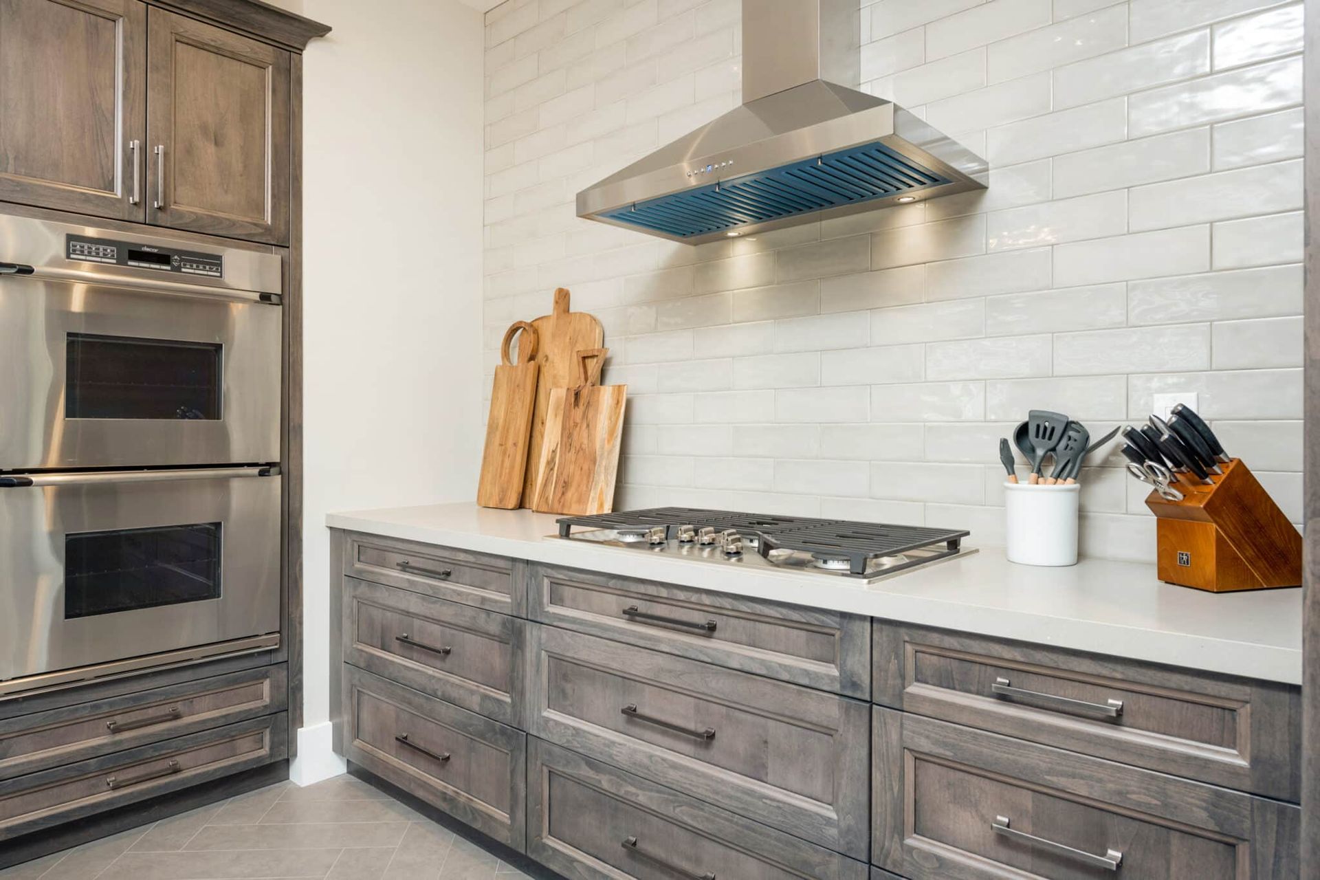 A kitchen with stainless steel appliances and wooden cabinets.