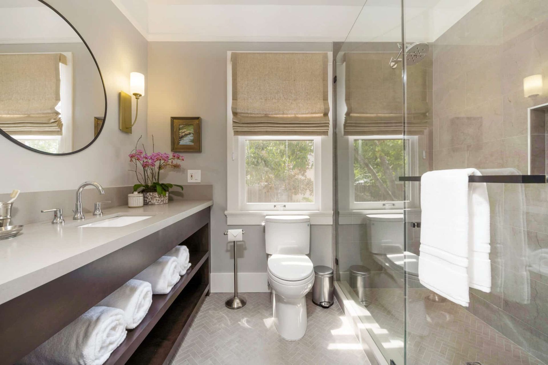 A bathroom with a toilet , sink , and shower.