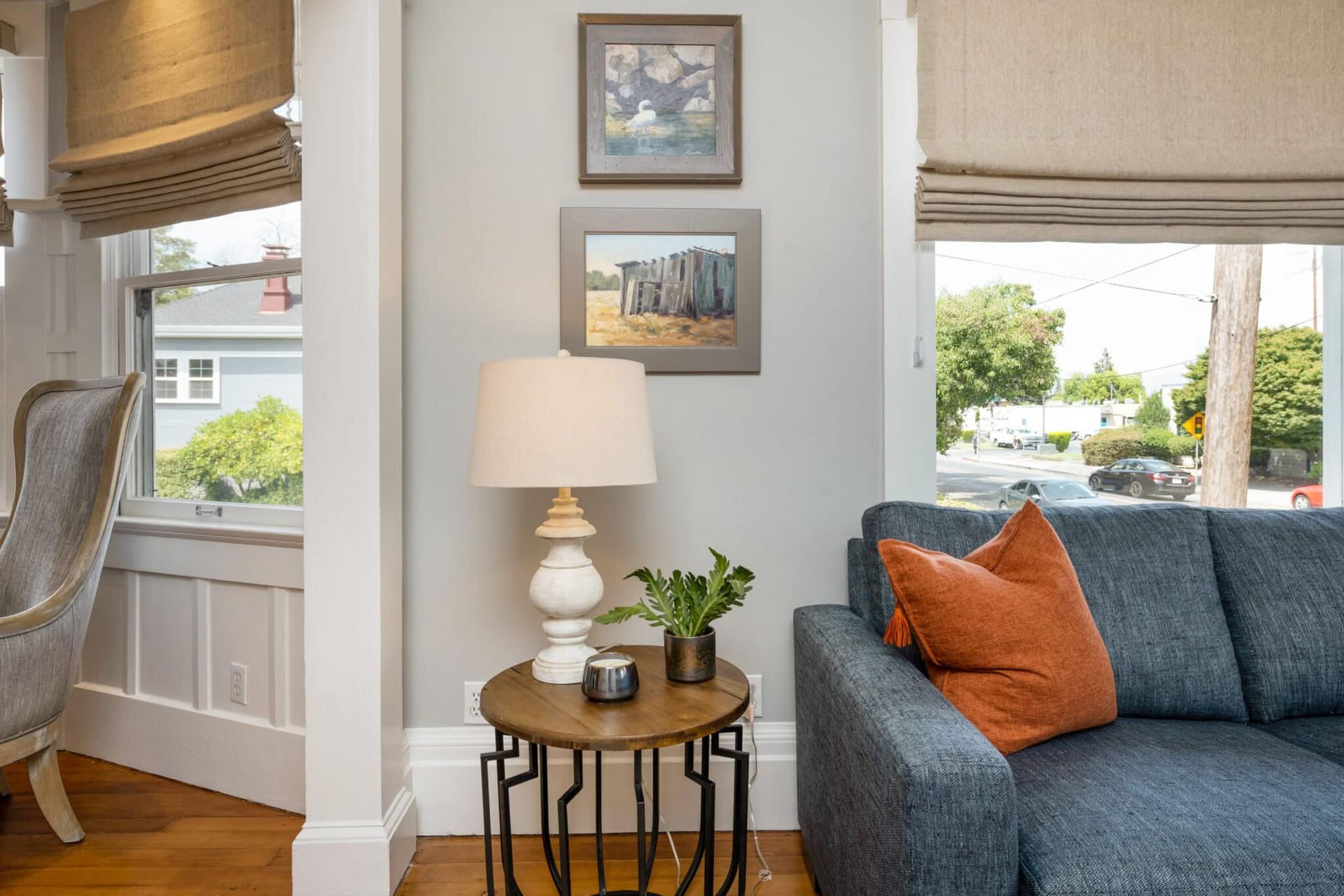 A living room with a couch , table , lamp and chair.