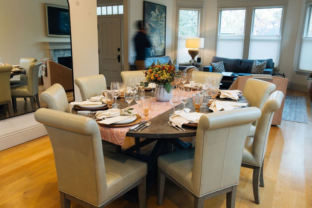 A dining room with a round table and chairs