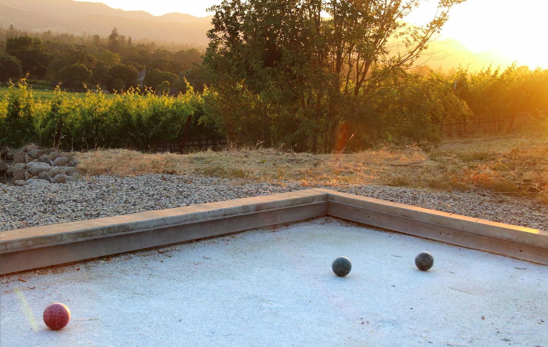 A couple of balls are sitting on top of a concrete surface.