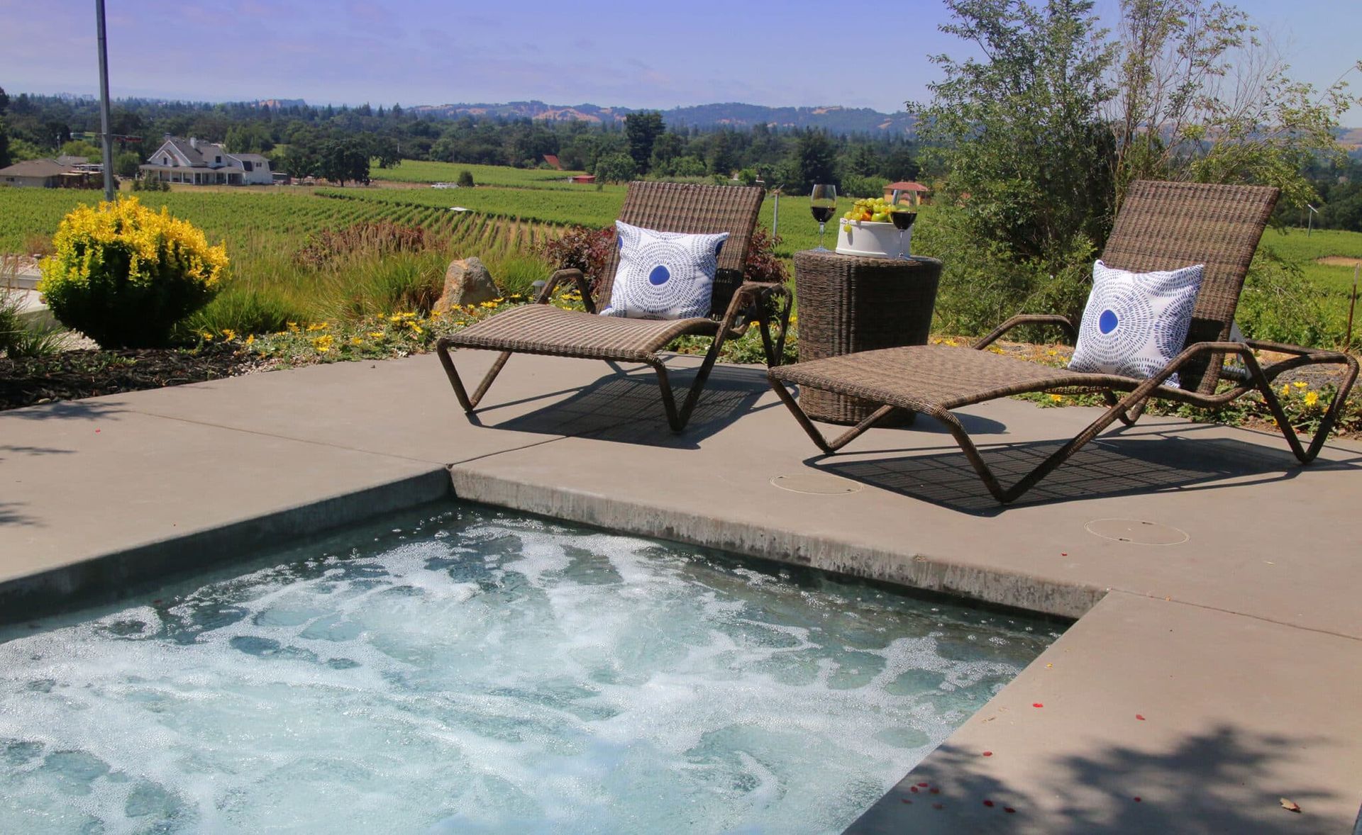 Two lounge chairs are sitting next to a swimming pool.