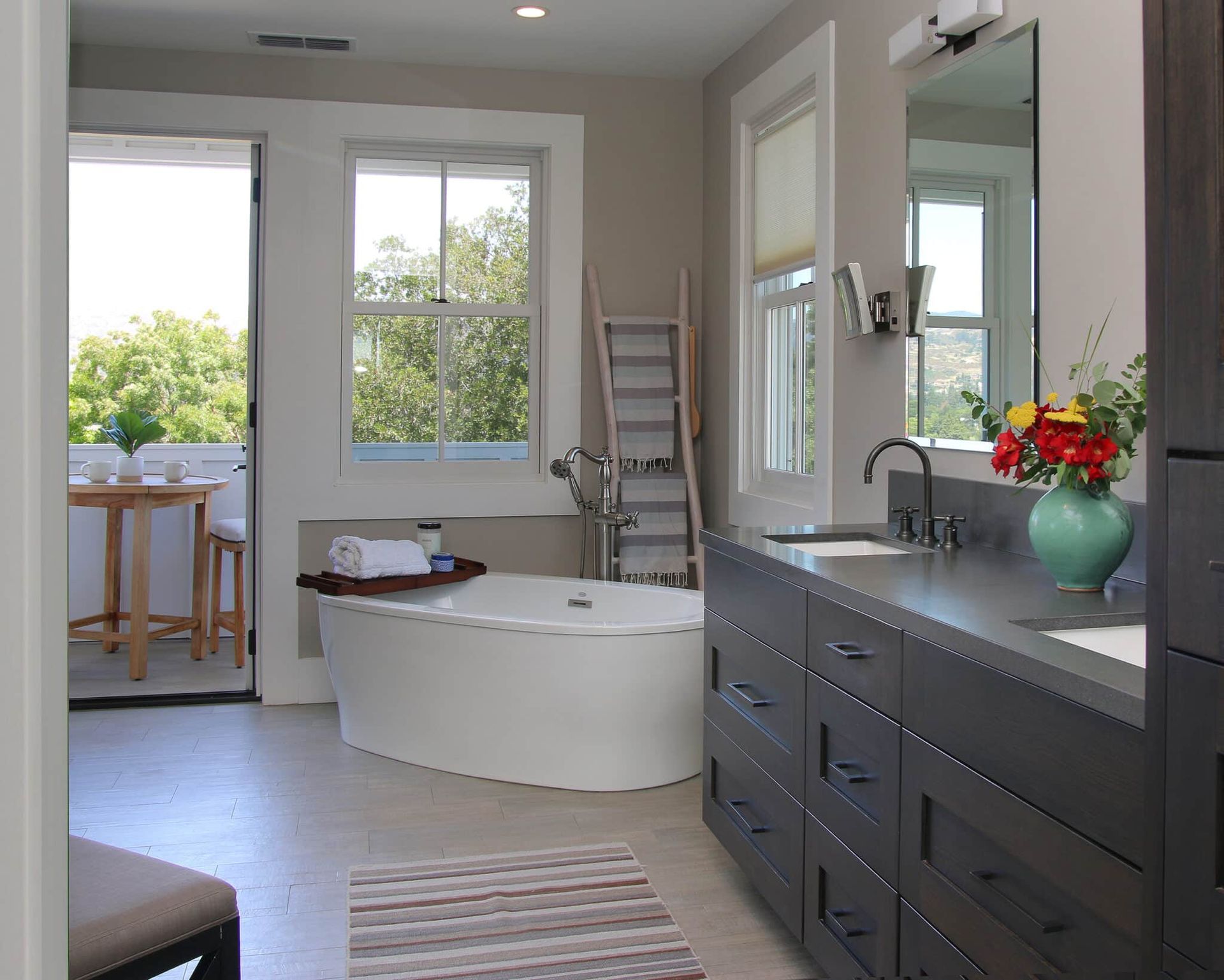 A bathroom with a large tub and a sink