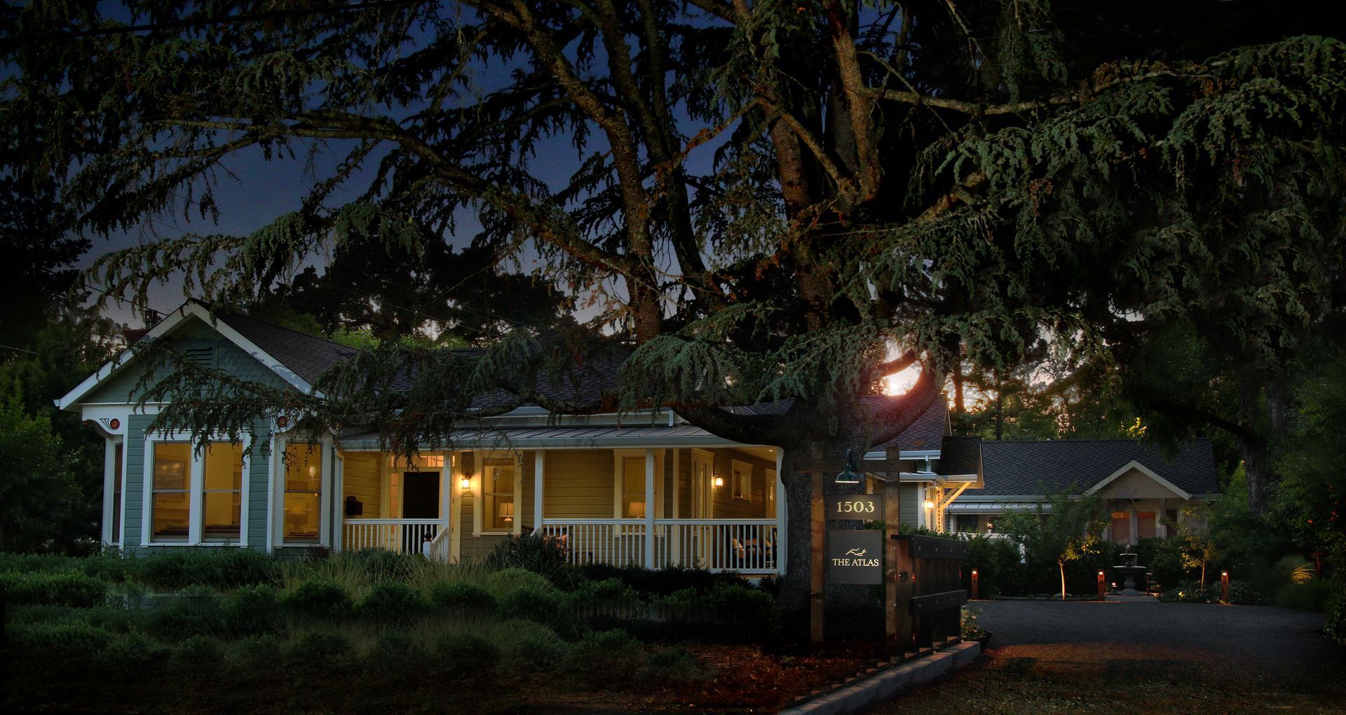 A small house with a porch and a lot of windows is for sale.