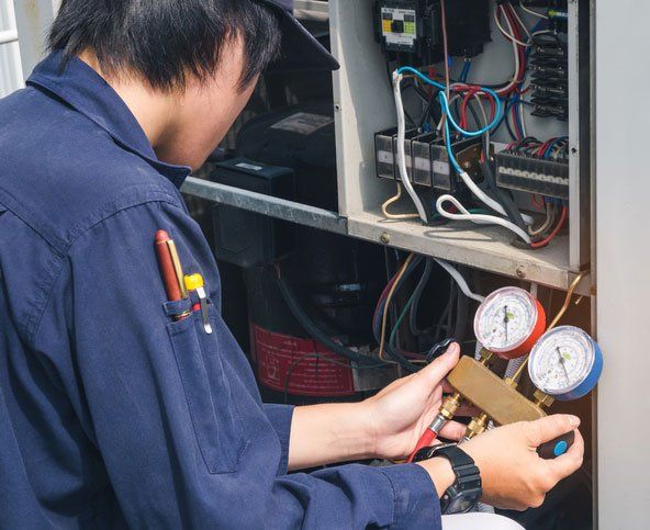 Technician Repairing Large Unit Air Conditioner