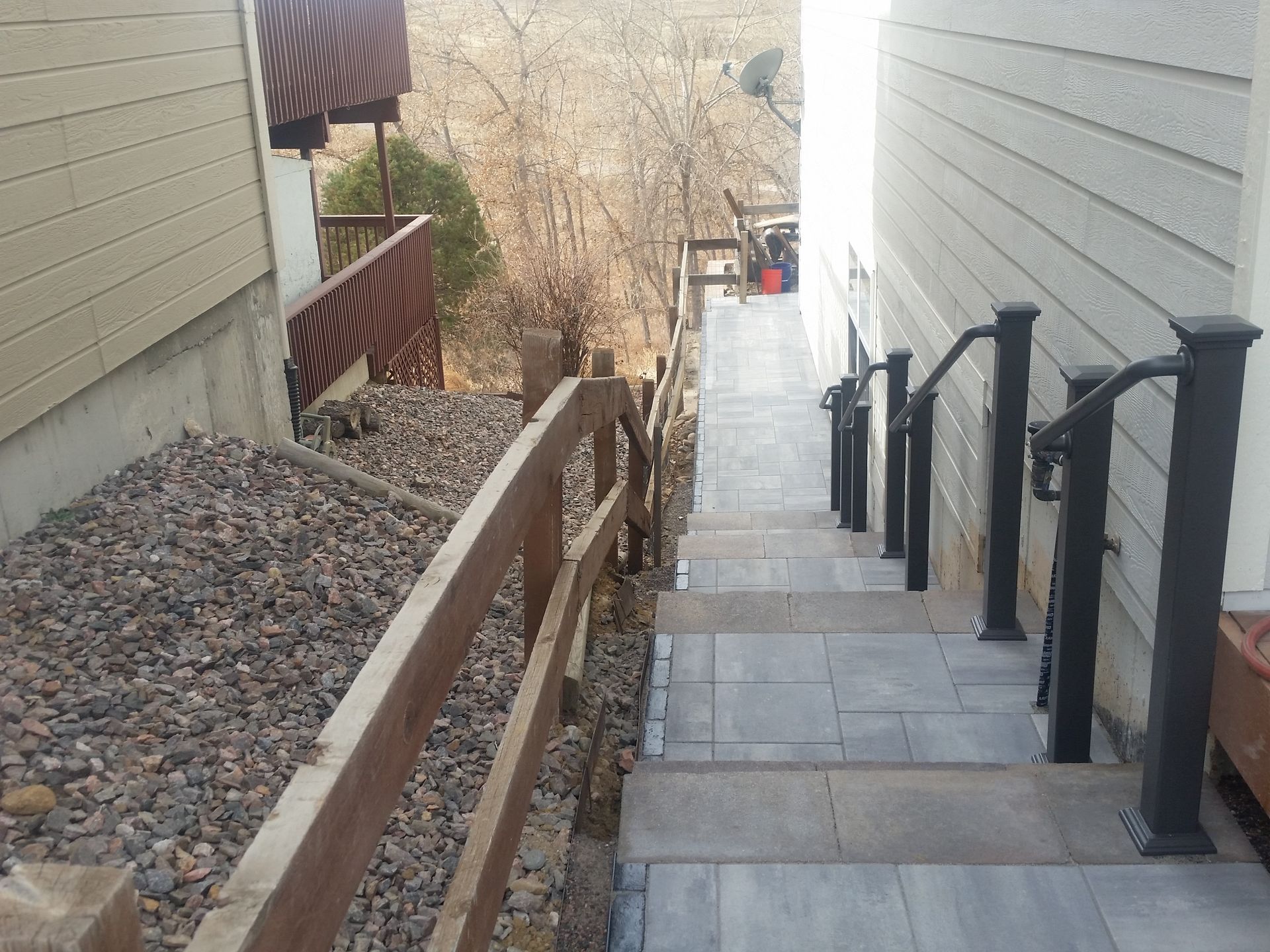 A set of stairs leading up to a house with a wooden railing