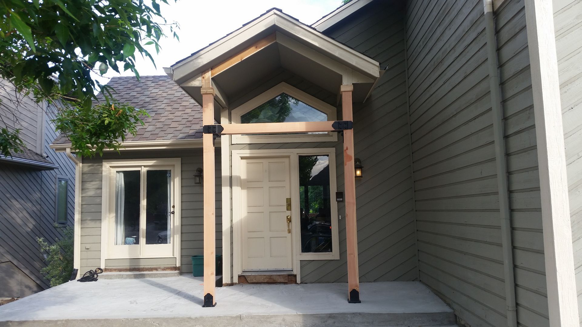 A house with a porch and a white door
