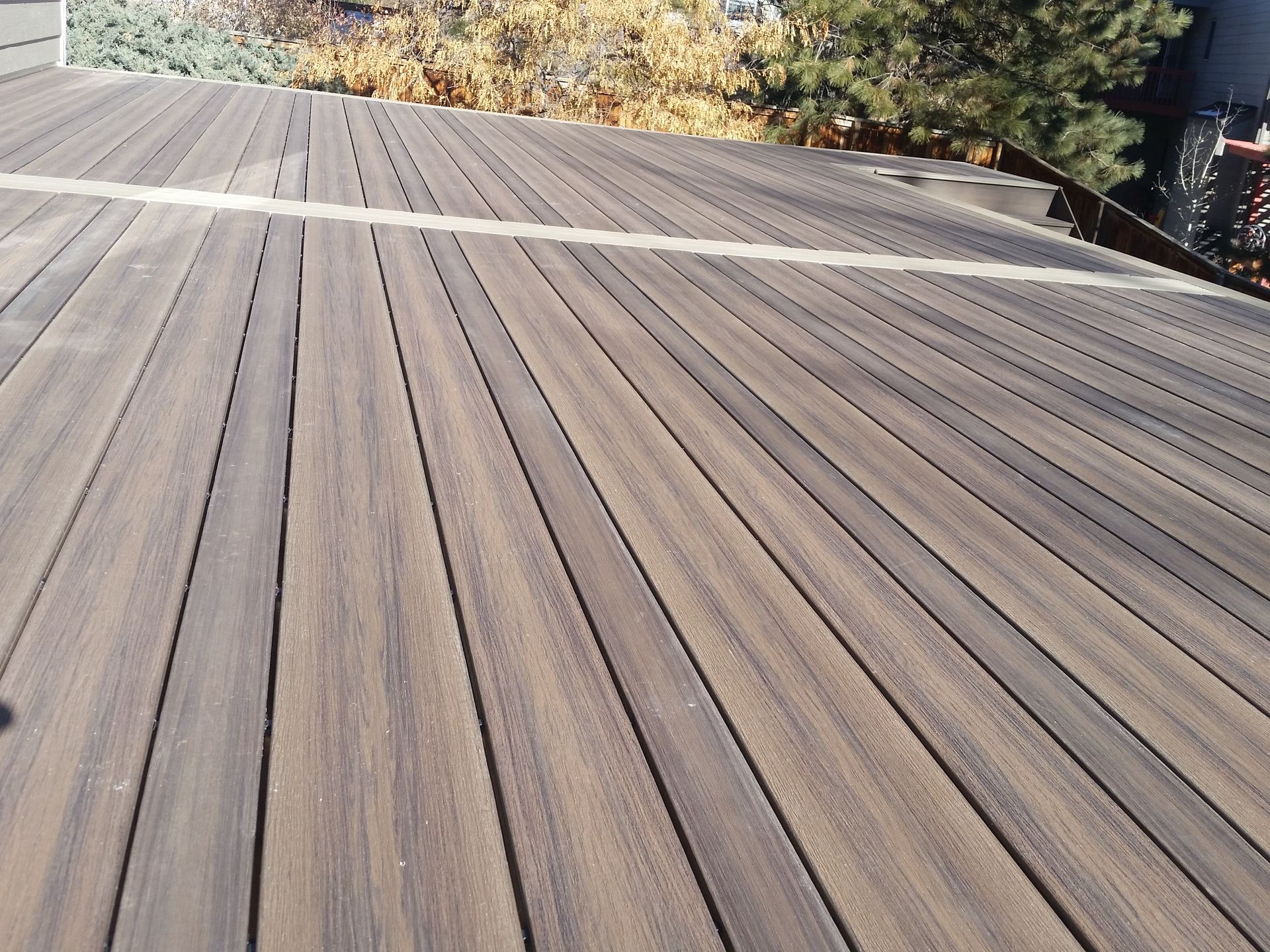 A PVC-coated composite deck with an ABC pattern using the deck boards. With a picture frame-style border. 