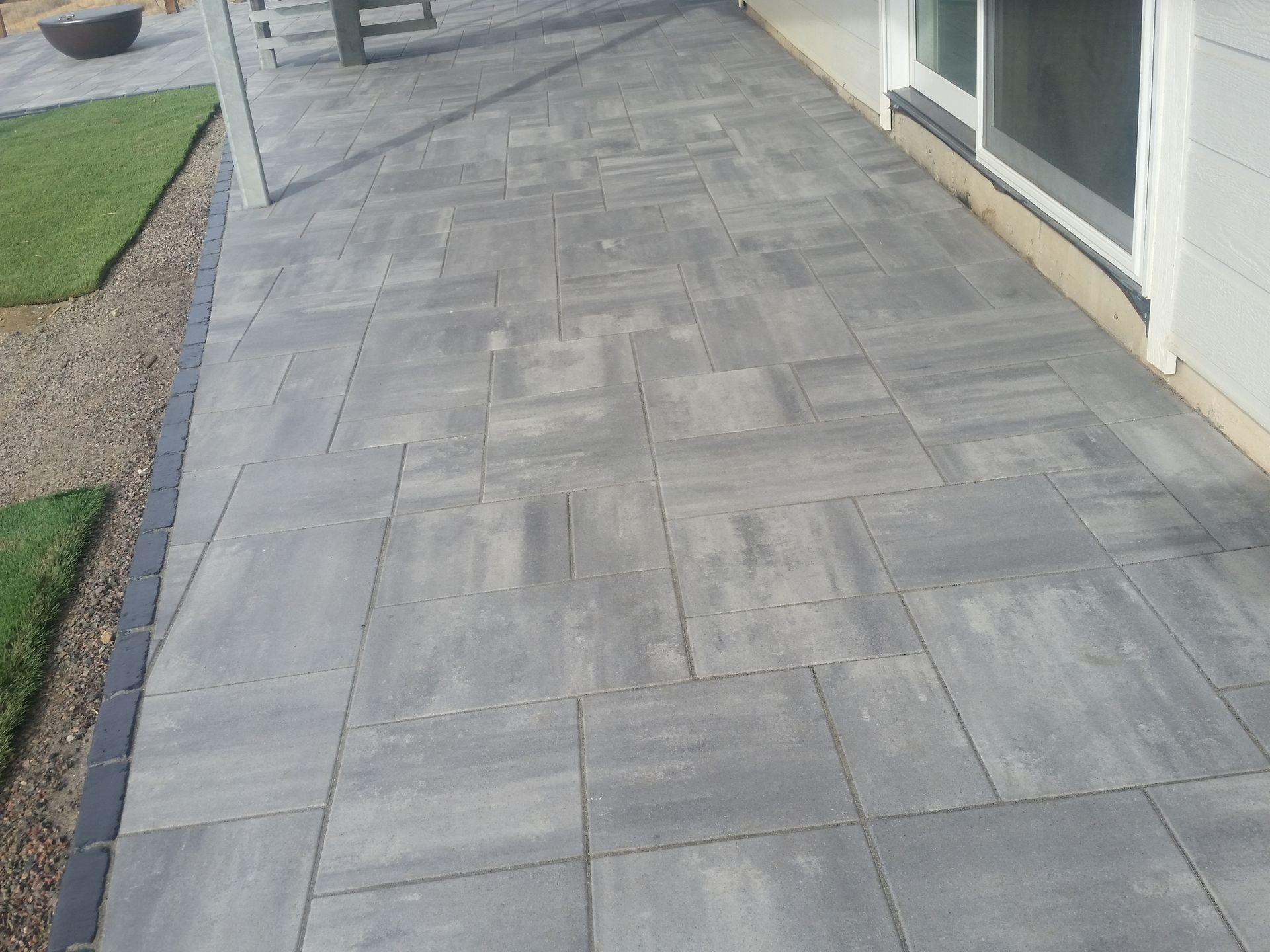 A patio with a sliding glass door in the background