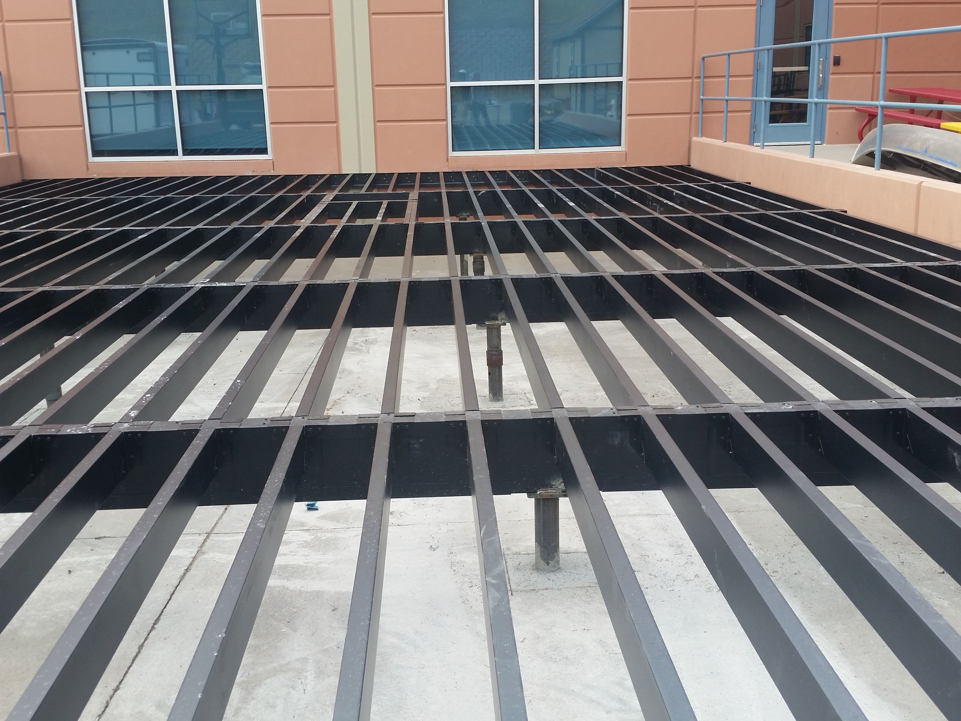 A building with a balcony and a fence in front of it