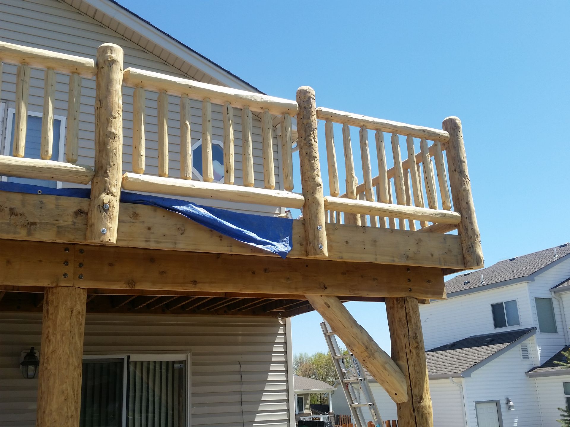 A wooden deck is being built in front of a house