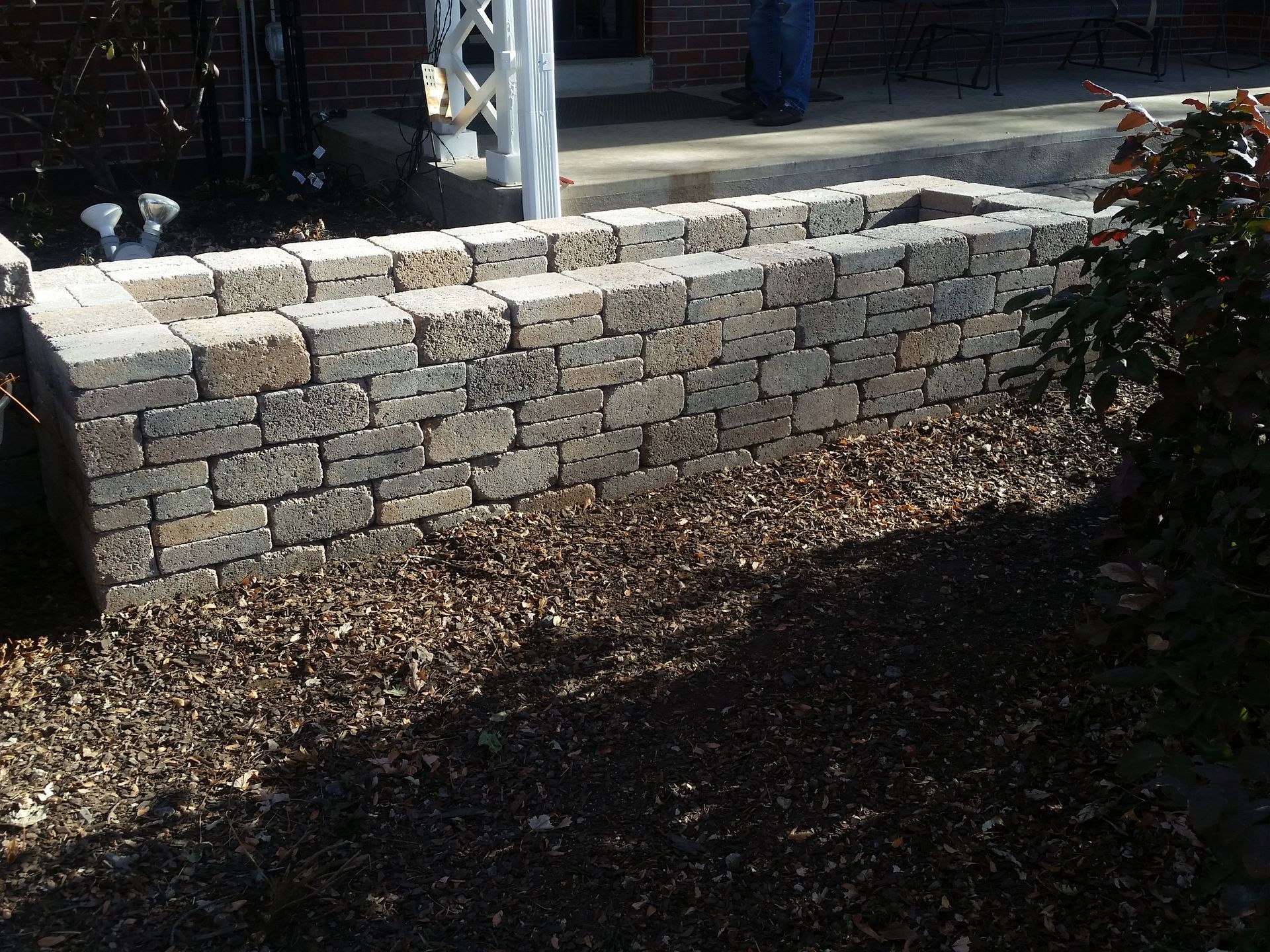 A brick wall with a hole in the middle of it