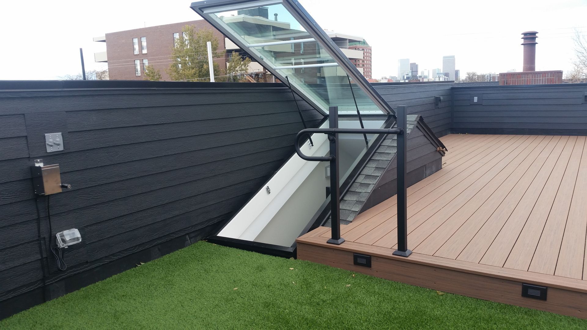 A rooftop deck with a staircase leading up to it