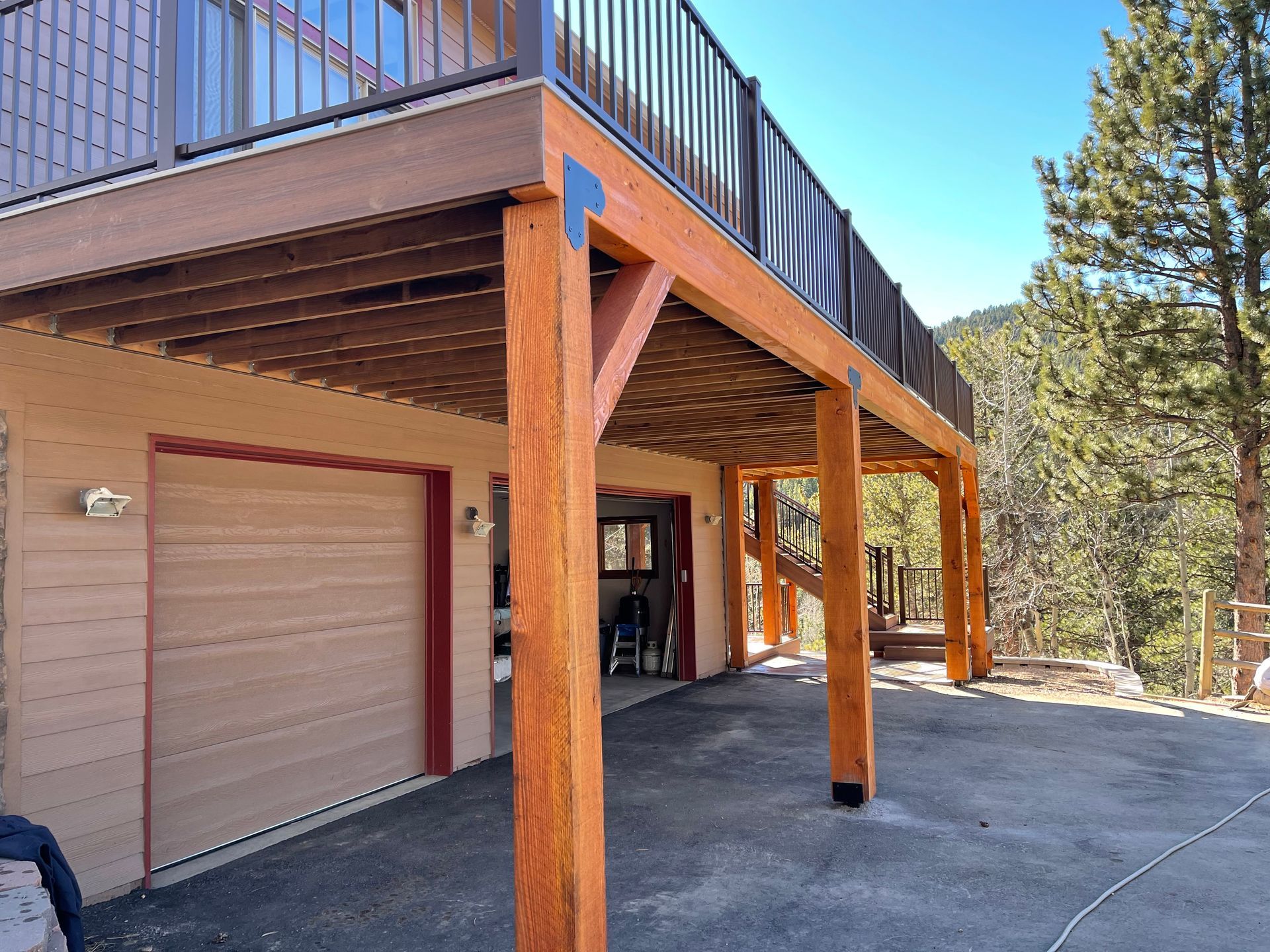A house with a wooden deck over a garage