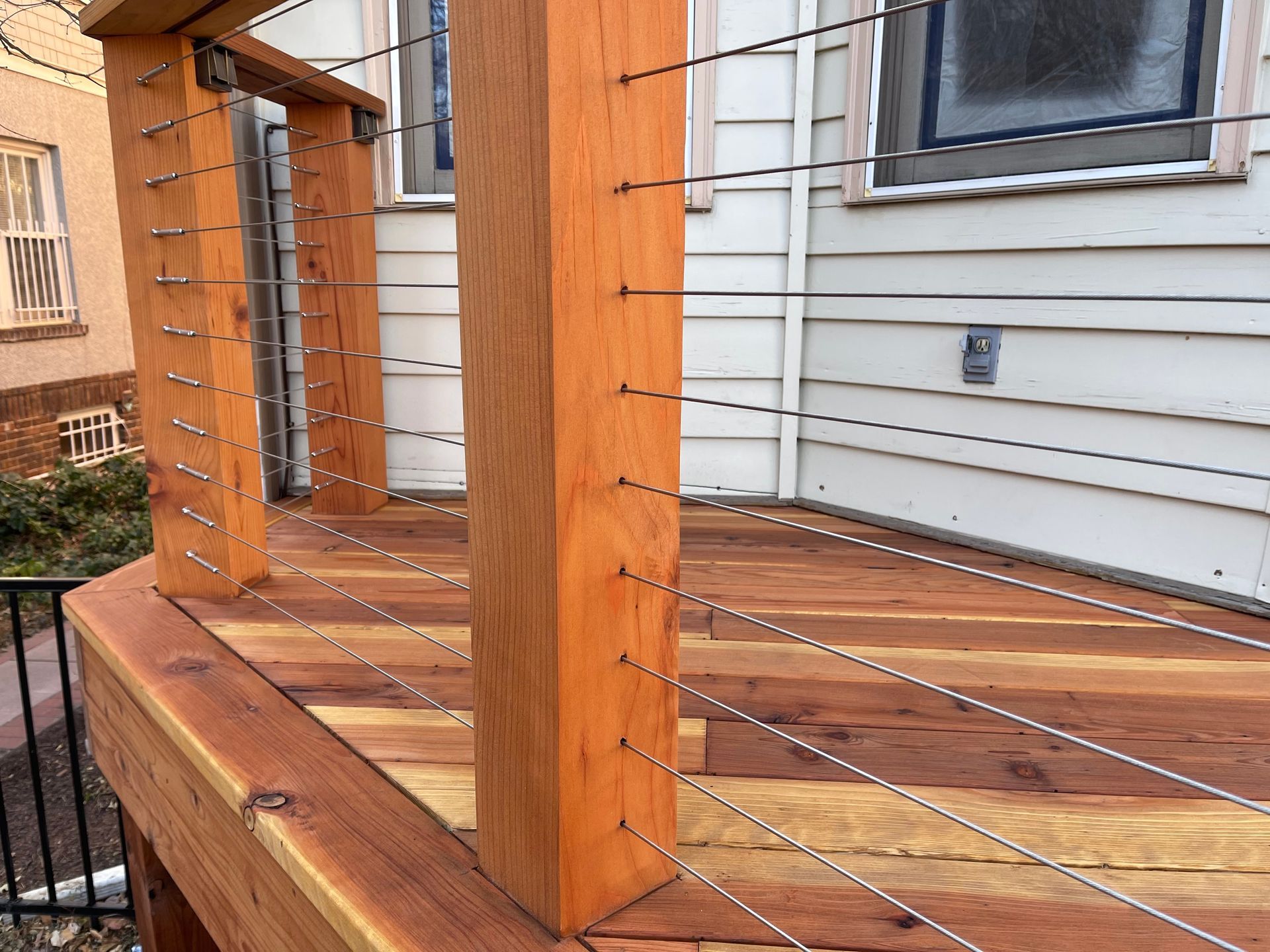 A wooden deck with a wire fence around it