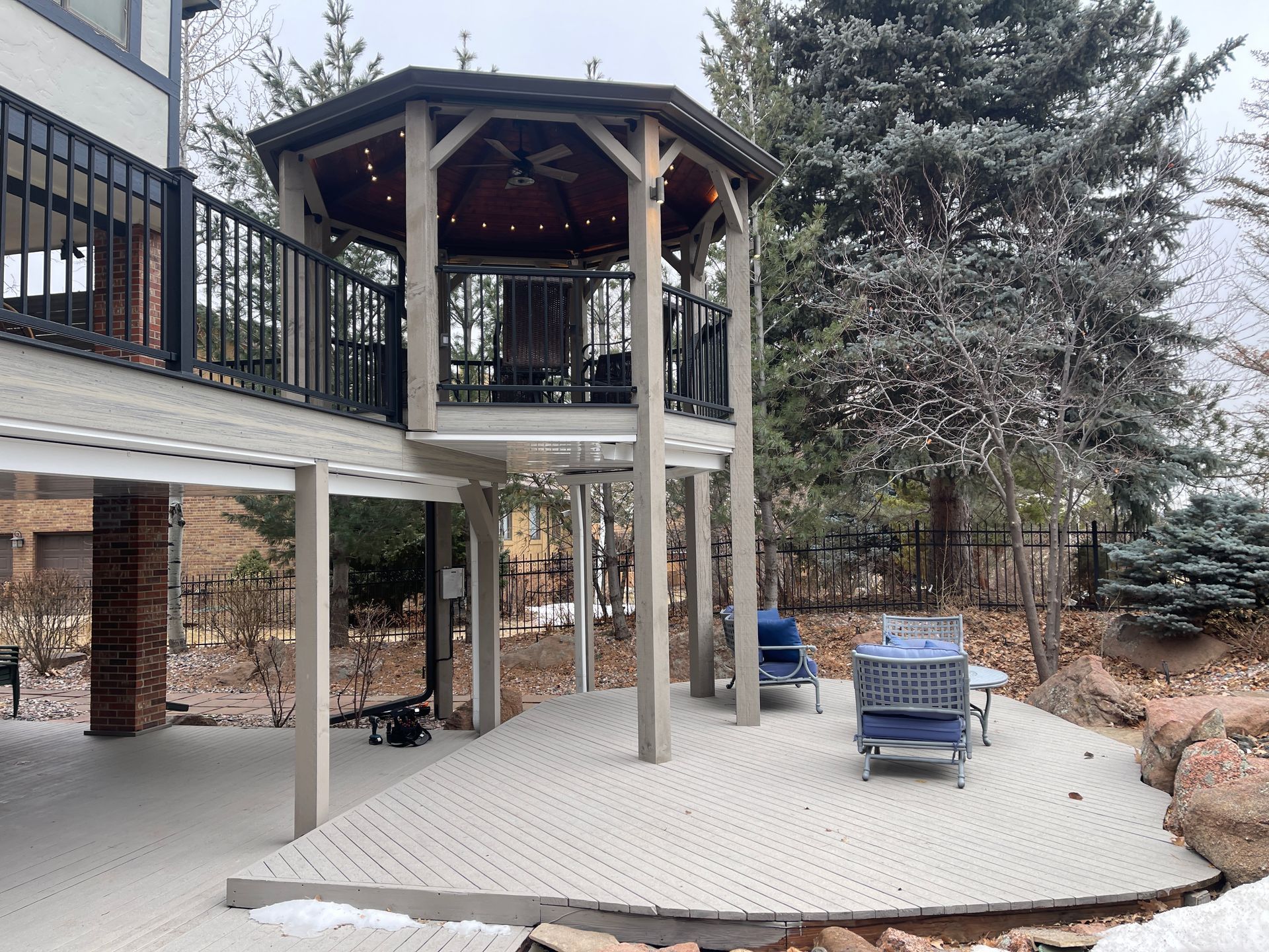 There is a gazebo on the deck of a house.