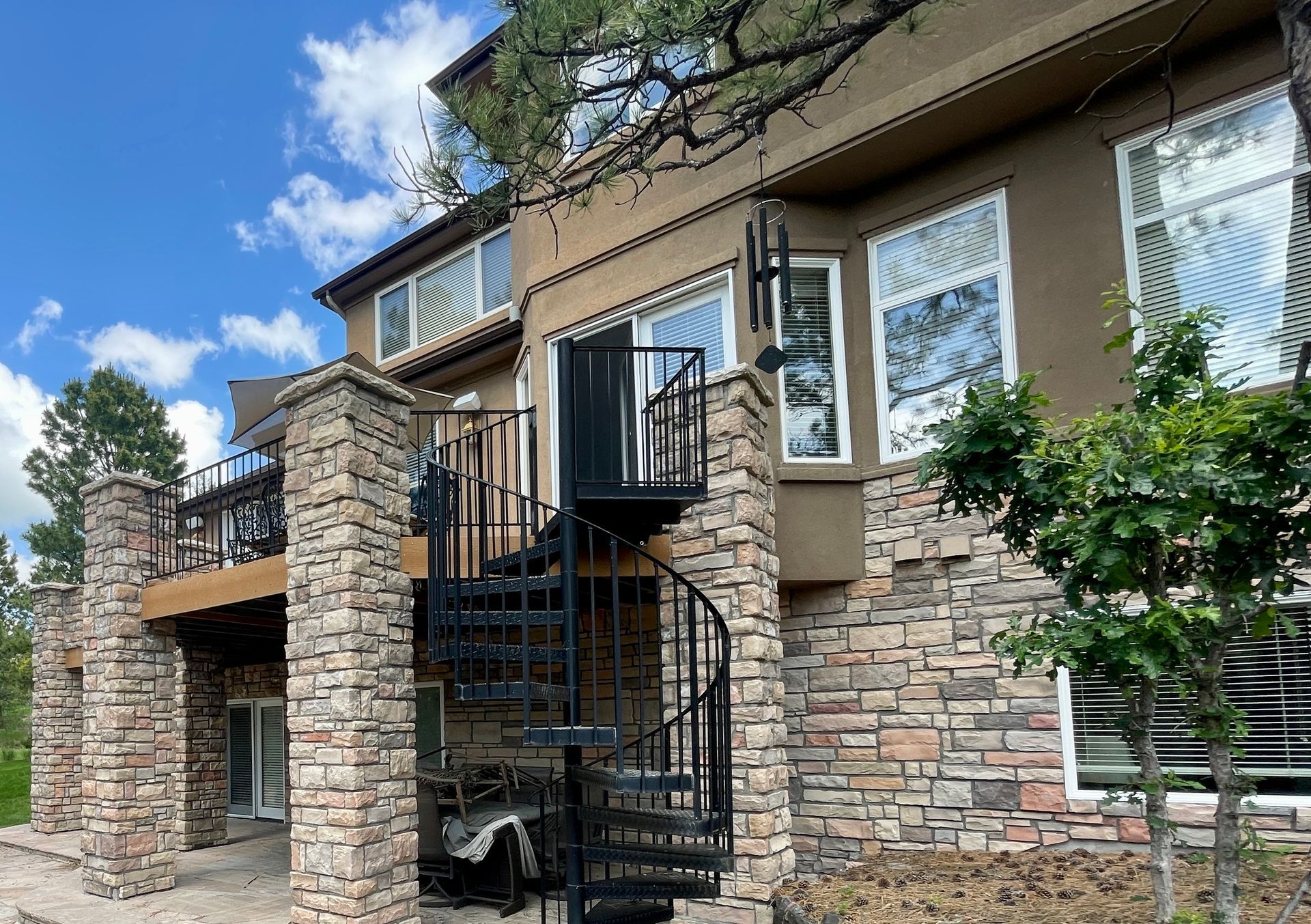 A large house with a spiral staircase on the side