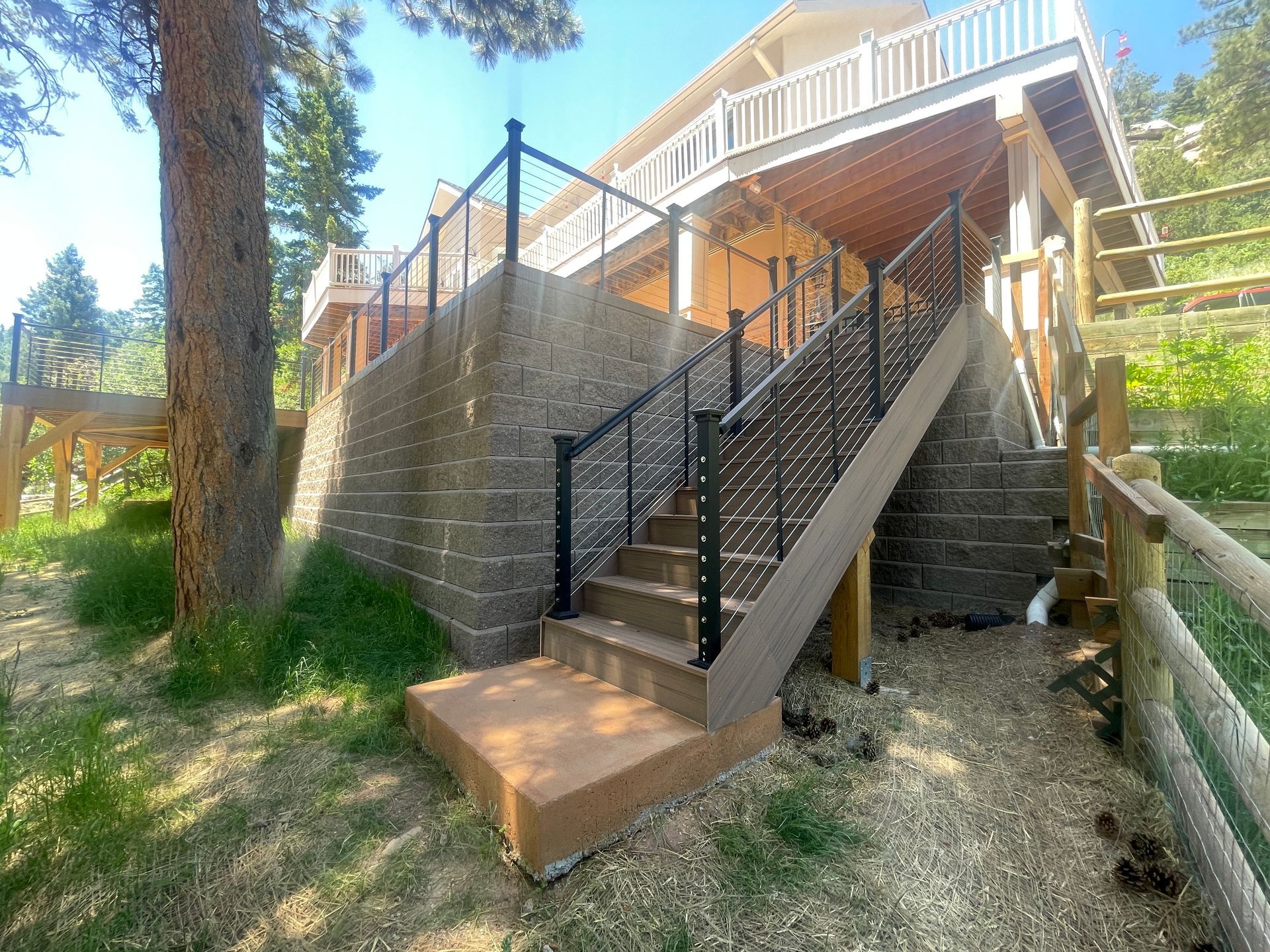 There are stairs leading up to the deck of a house.