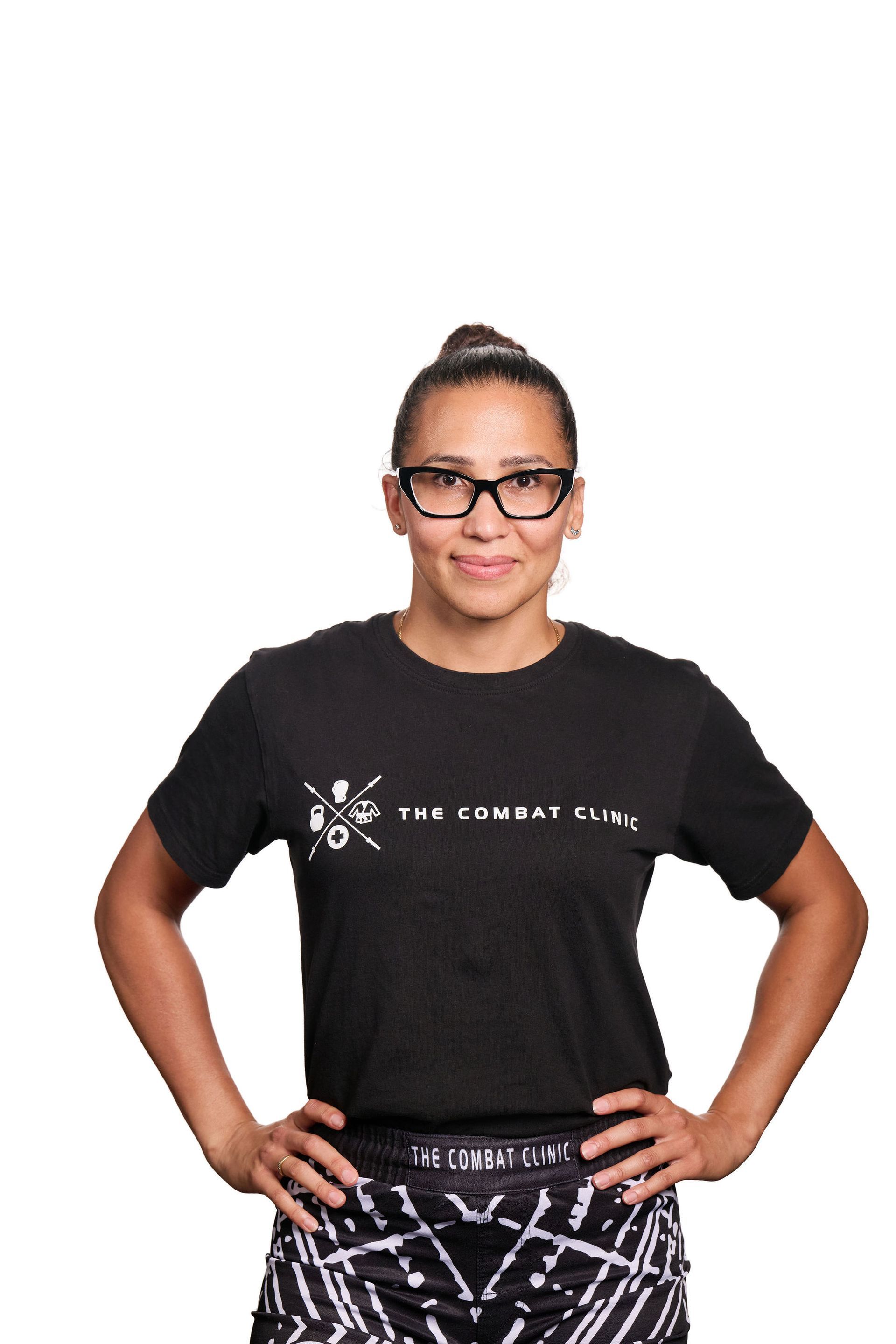 Man with tattoos smiles, stands beside