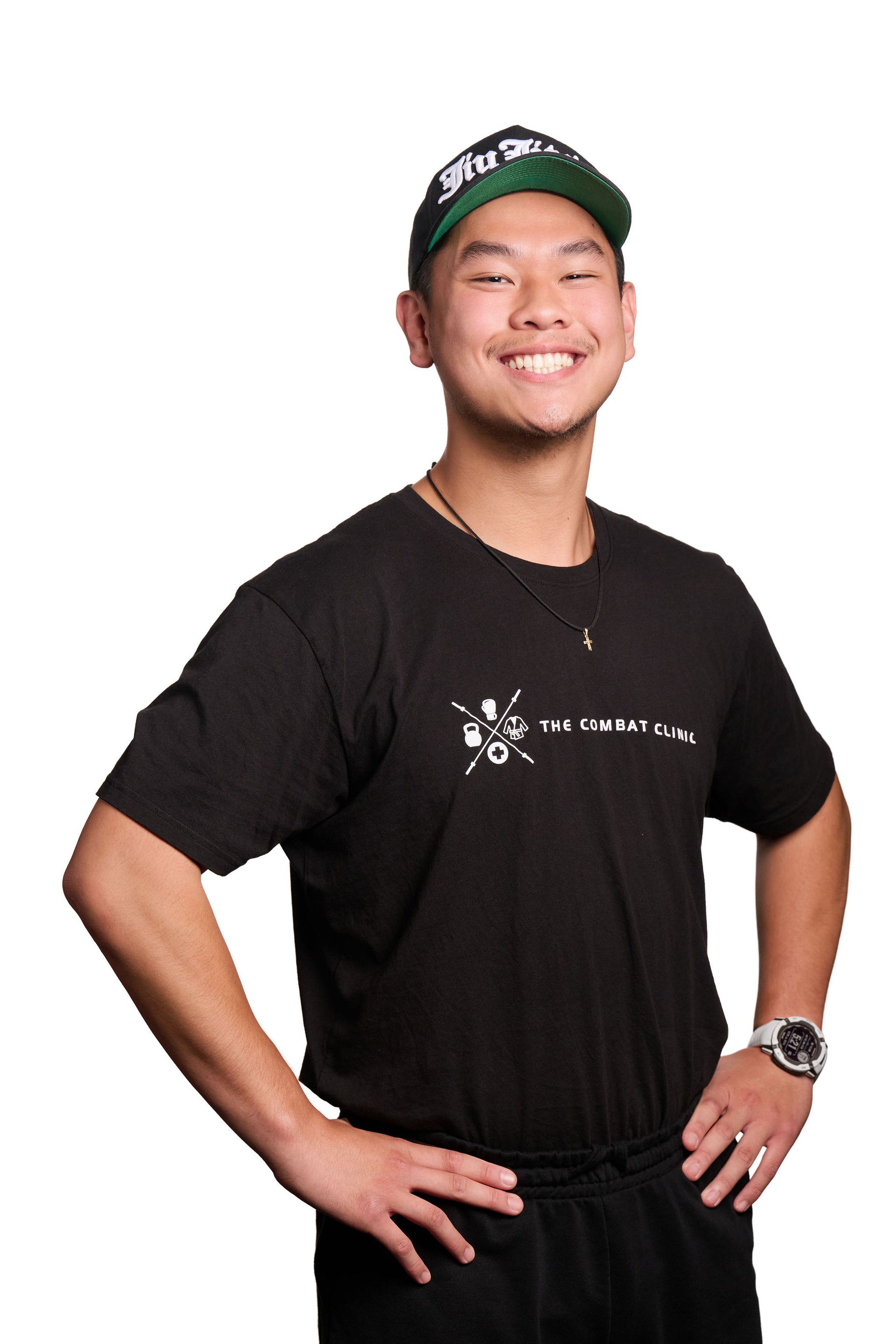 Man with tattoos smiles, stands beside