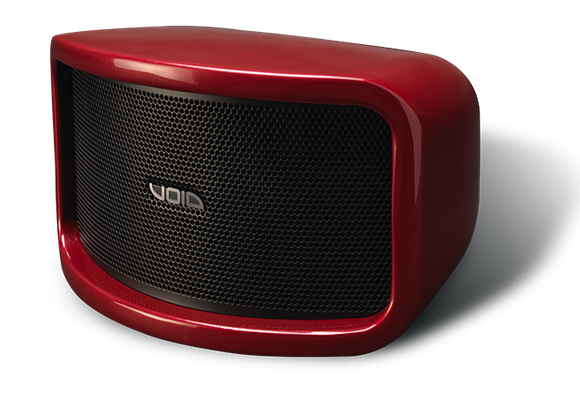 A red void speaker is sitting on a white surface