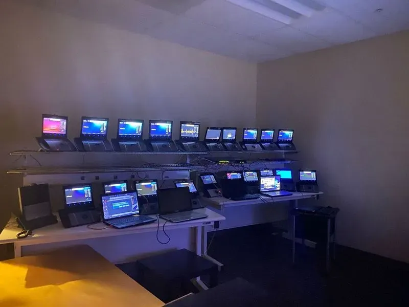 A room filled with lots of laptops on desks