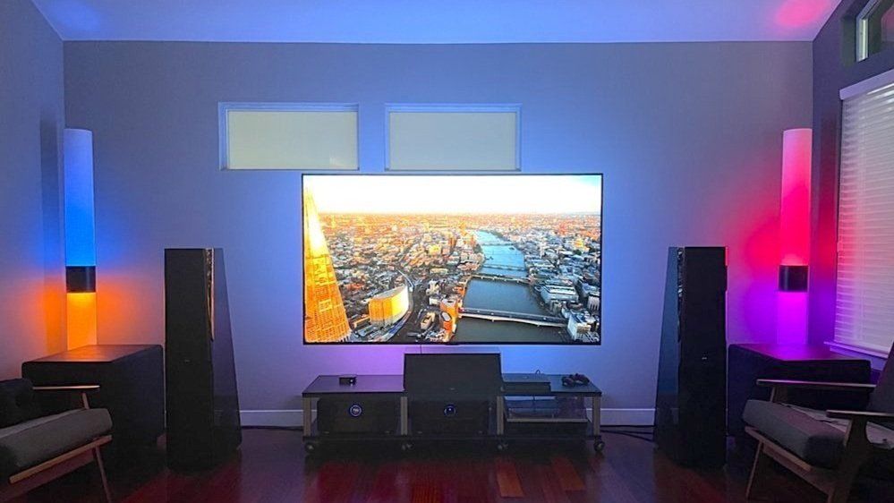 A living room with a large flat screen tv hanging on the wall.