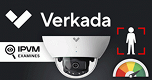 A security camera with a man standing in front of it.