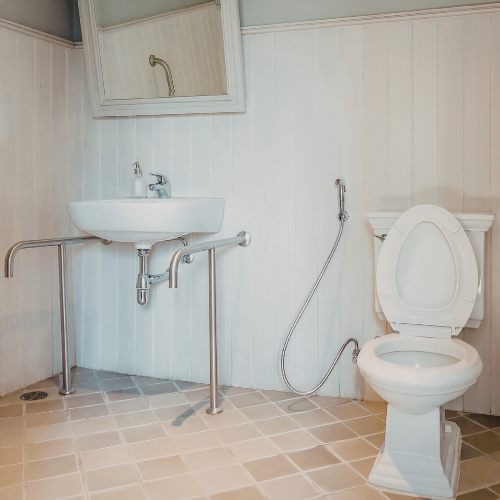 A black doormat on blue-tiled floor in front of a gray door and glass wall.
