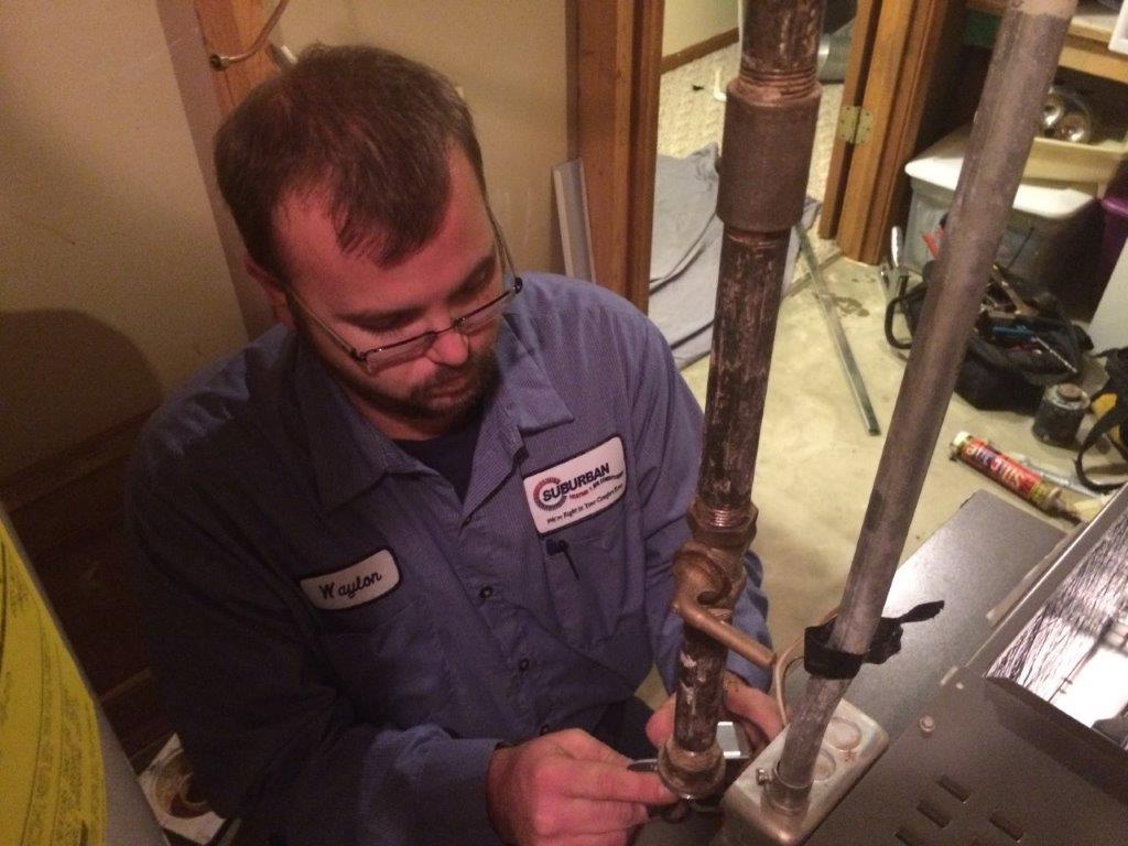 Technician Repairing AC — Kalamazoo, MI — Suburban Heating & Air Conditioning
