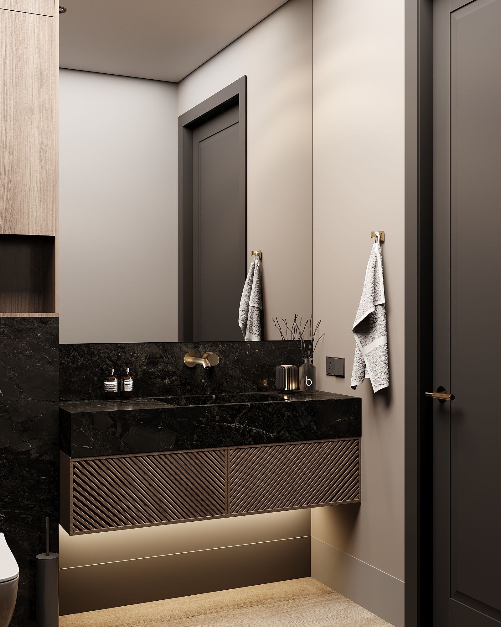A modern bathroom with a black stone vanity, textured wooden cabinets, under-cabinet lighting, and a towel on the wall.