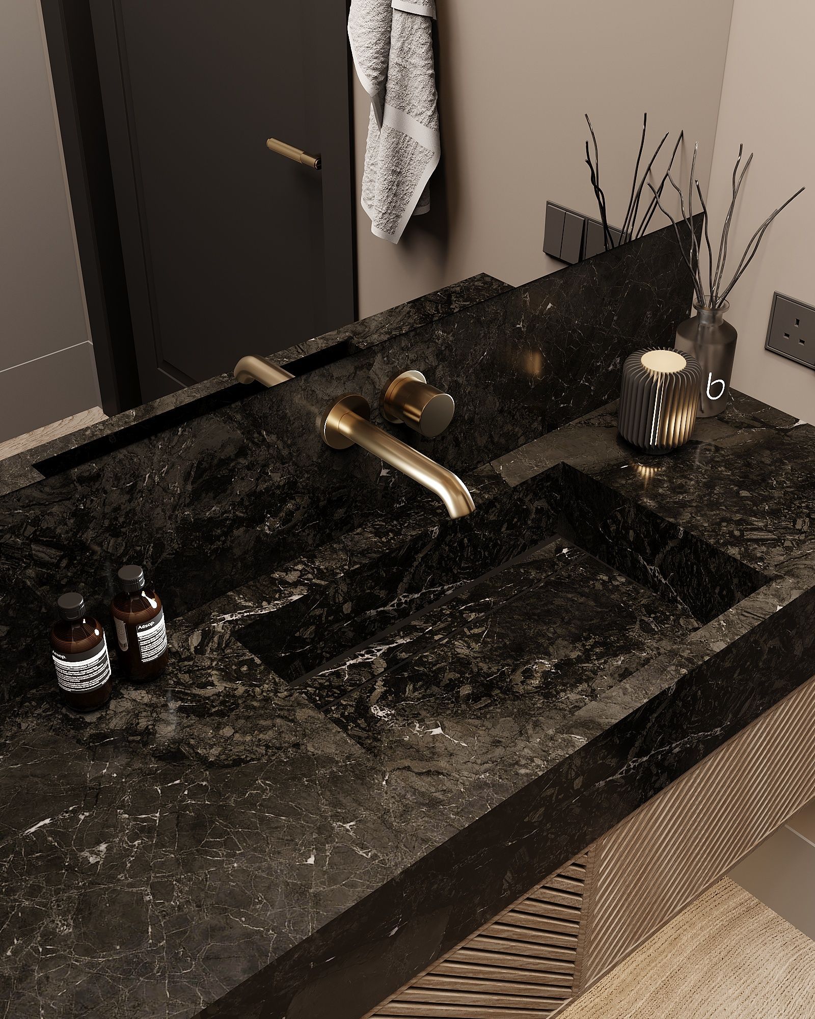 A sleek bathroom vanity featuring a black stone countertop, integrated basin, and brushed gold faucet.