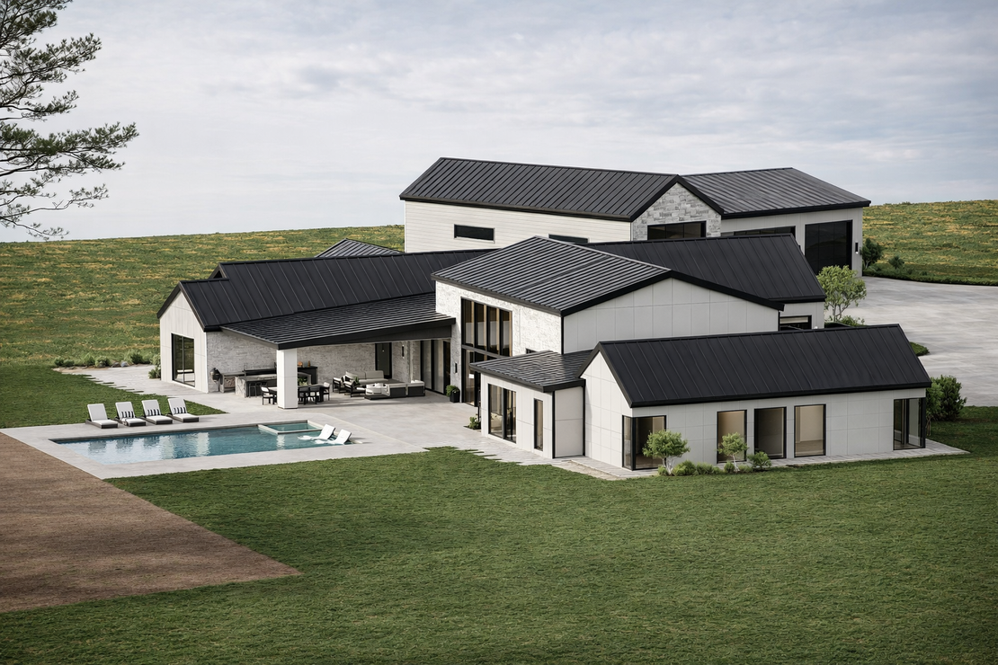 A modern white house with a dark metal roof, pool, and patio area, set in a grassy, open landscape.