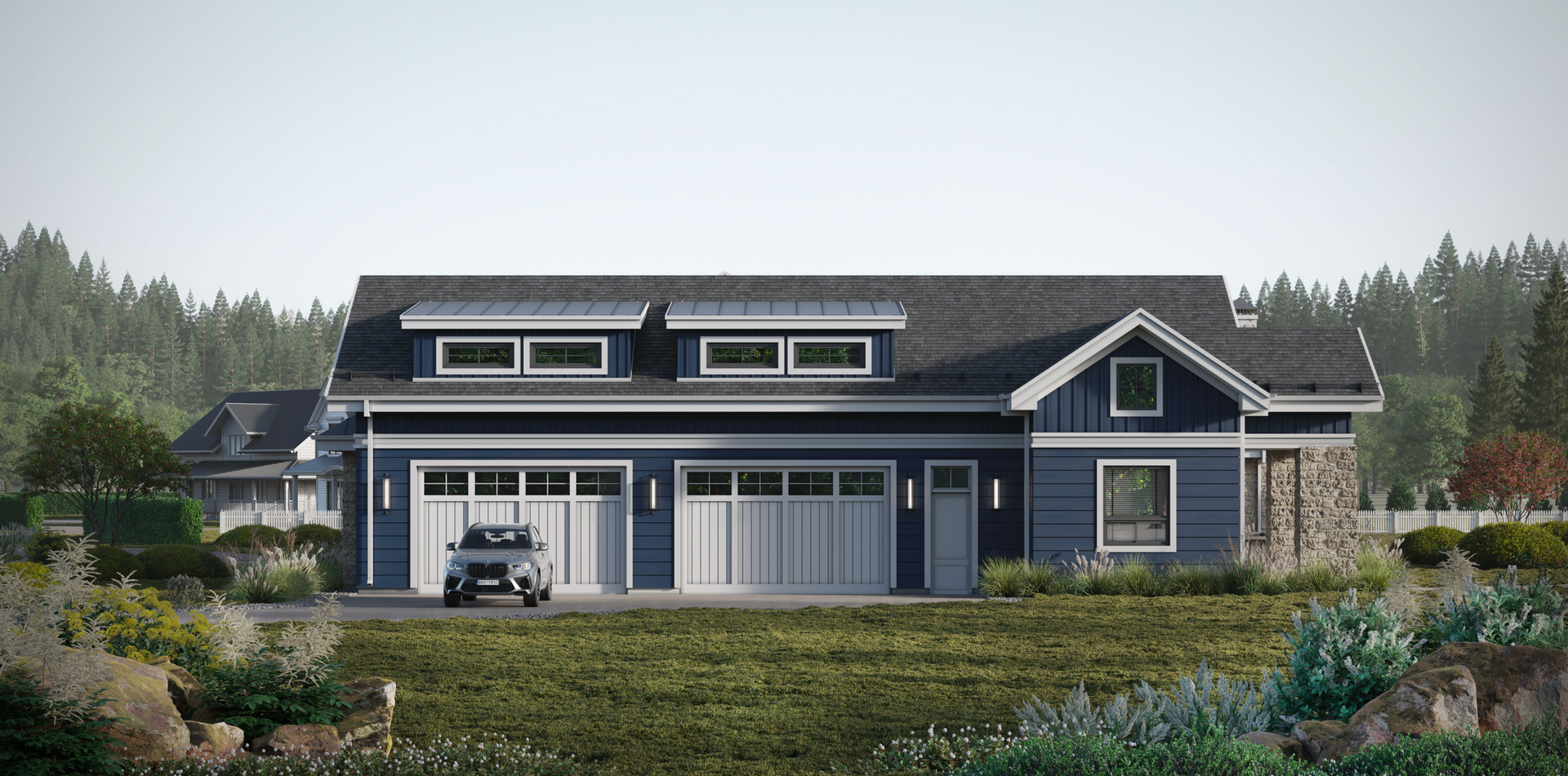 A blue house with a two-car garage and a dormer roof, set against a backdrop of trees and a grassy yard.
