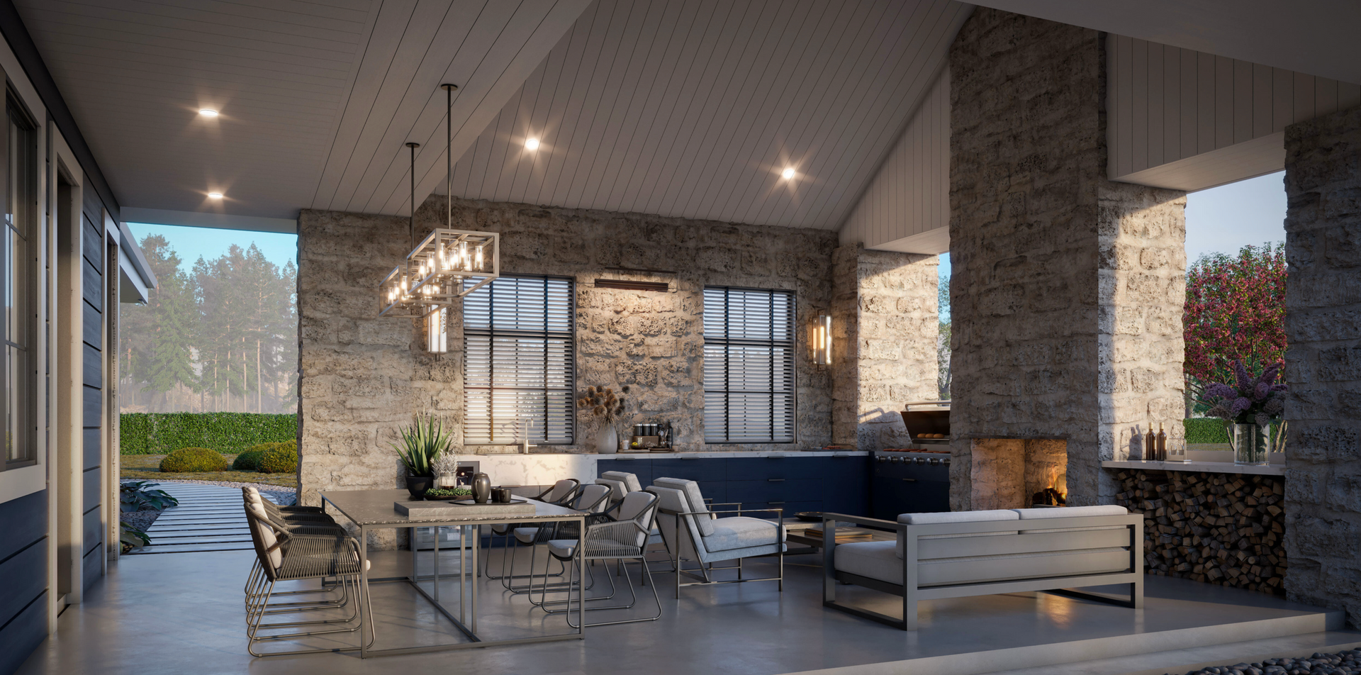 A covered outdoor patio with stone walls, a fireplace, dining area, and cozy seating under a vaulted ceiling.