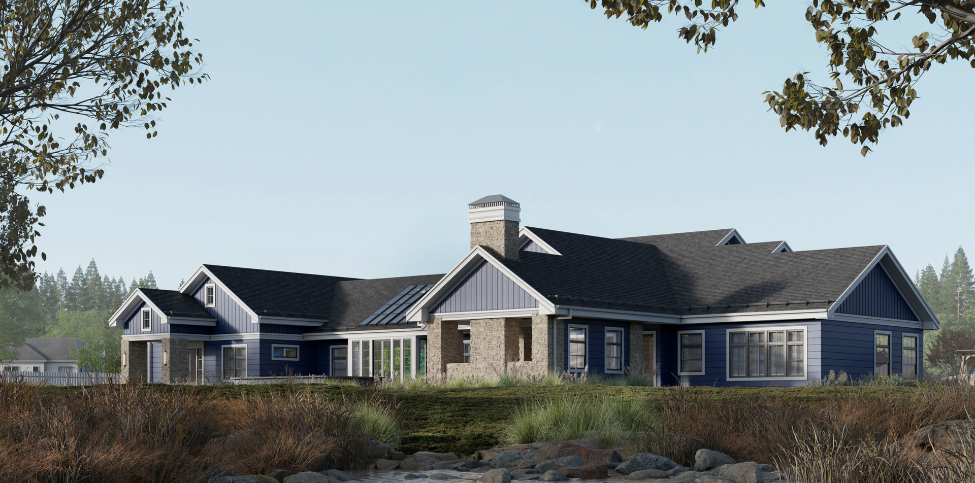 A one-story blue house with stone accents, a dark shingled roof, and a chimney, situated in a grassy, natural landscape.