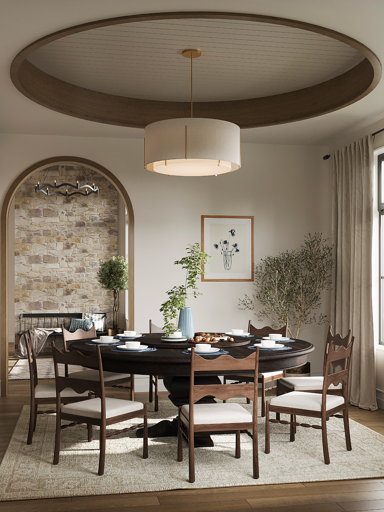 A dining room with a round wooden table, chairs with white cushions, a pendant light, and an arched wall feature.