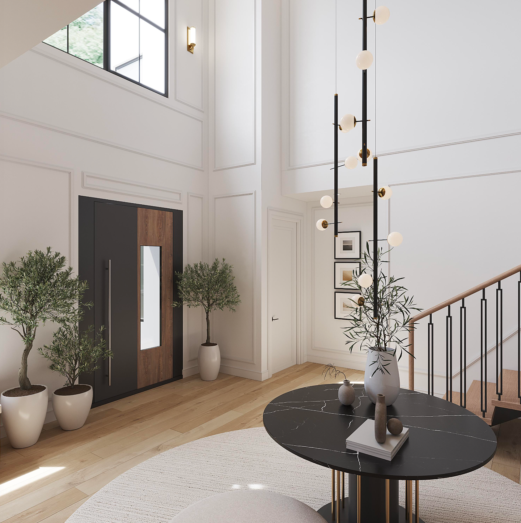 A modern, sunlit foyer features a black marble table, tall pendant light, potted olive trees, and a wooden entrance door.