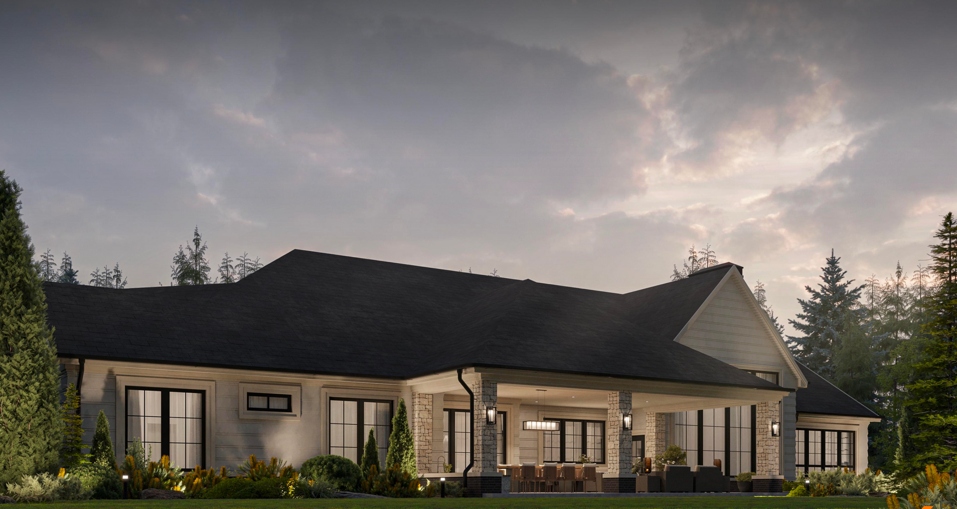 A wide, single-story house with a covered back patio and dark roof, set against a forest at dusk.