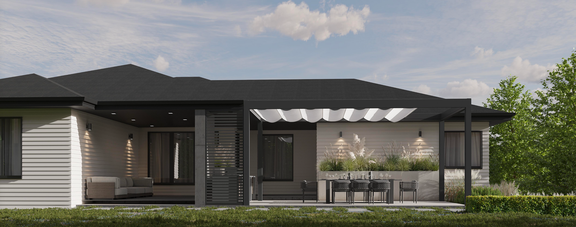 A modern house exterior with a patio, outdoor dining area, a white retractable canopy, and black trim against a lawn.