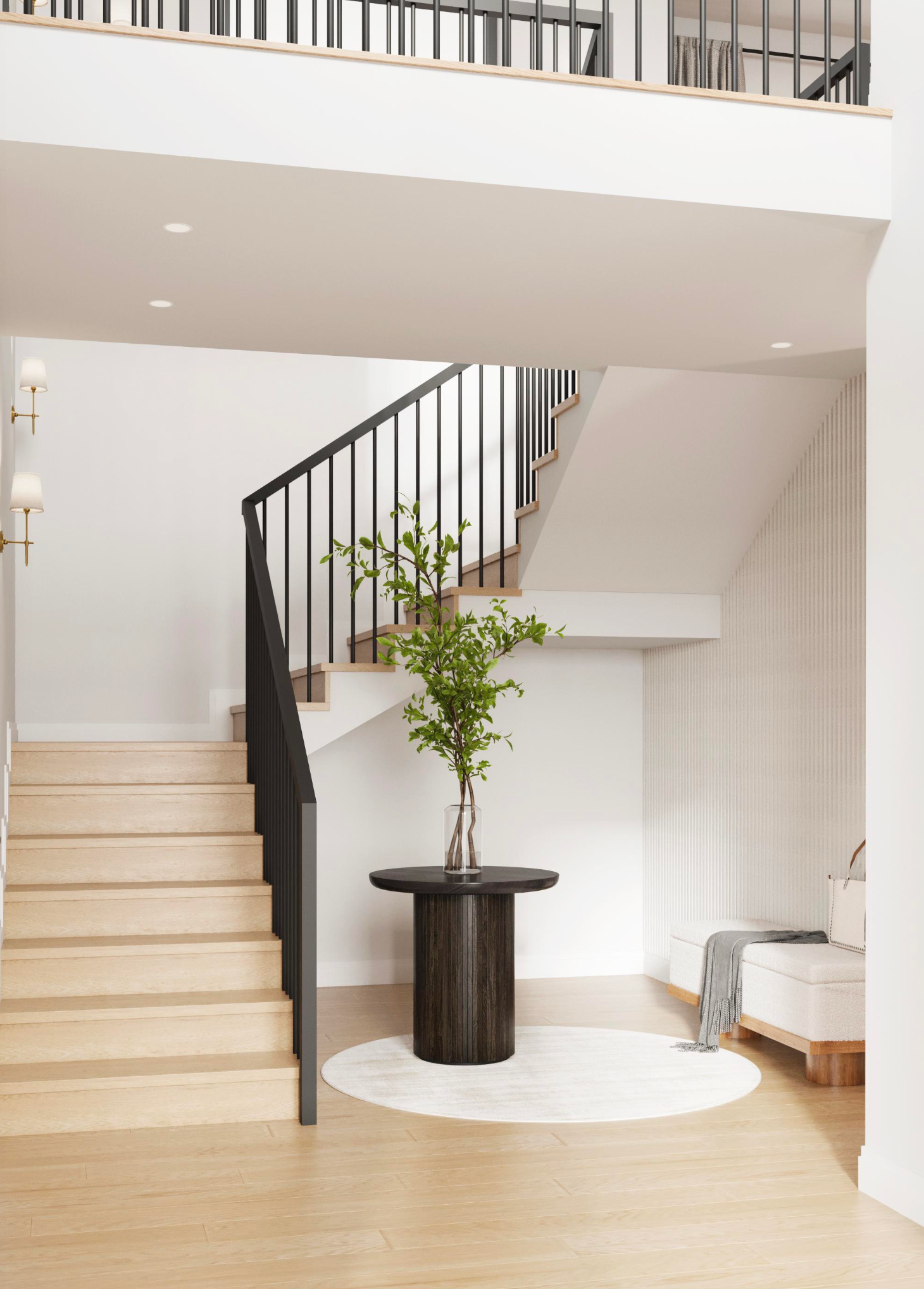 A minimalist foyer features a light wood staircase, a dark circular pedestal table with greenery, and a white rug.