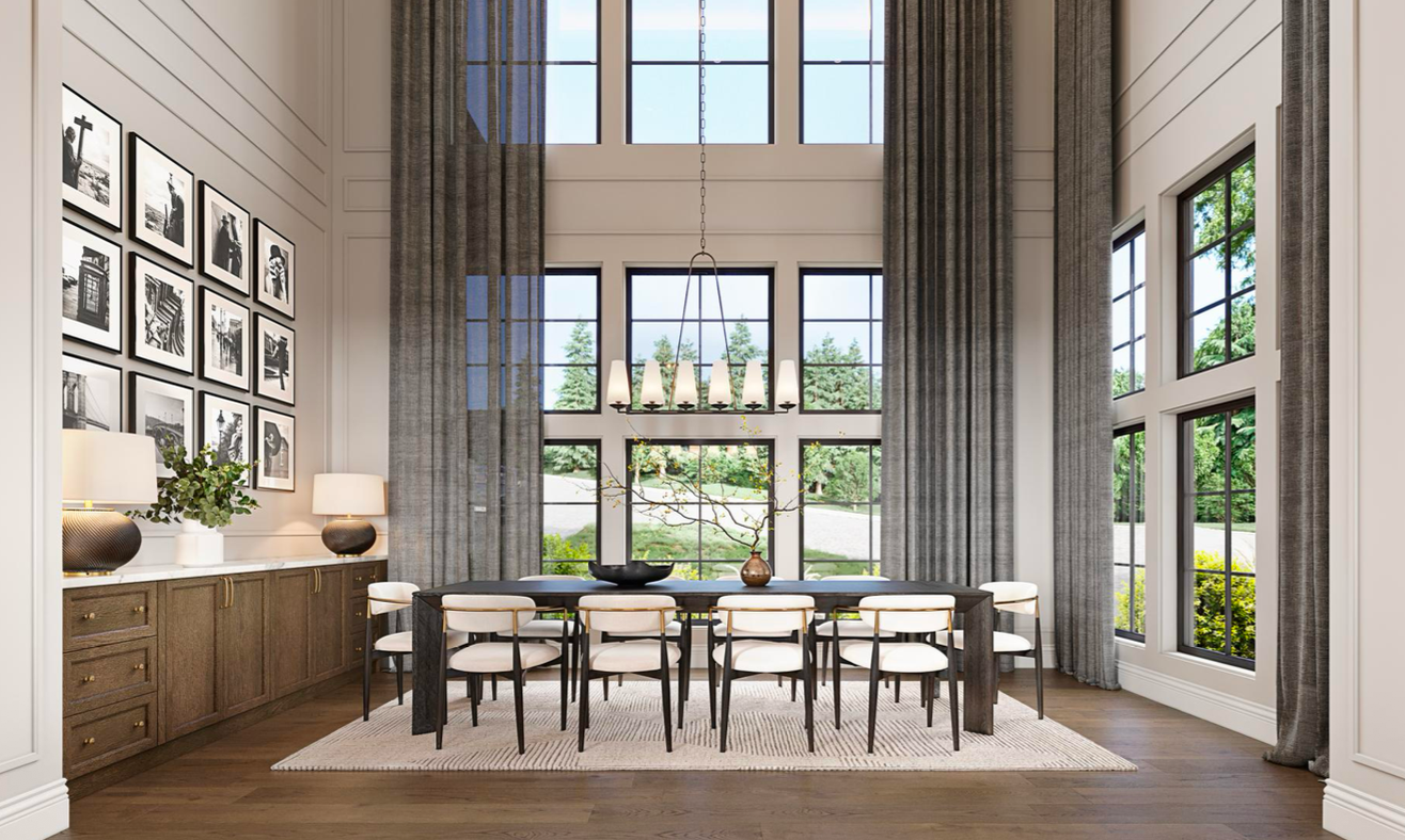 A bright, modern dining room with a long table, eight white chairs, tall windows, and a gallery wall of framed photos.