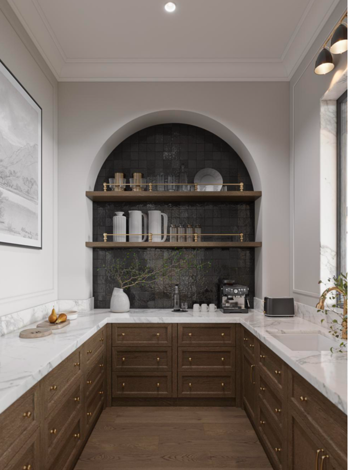 A U-shaped kitchen with dark wood cabinets, white marble countertops, and an arched niche featuring dark tile and shelves.
