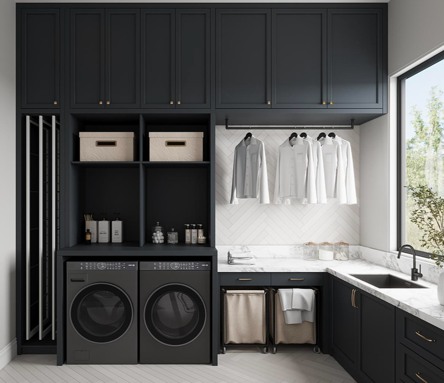 A modern, dark-themed laundry room with built-in cabinetry, dual washers, a sink, and hanging racks for clothing.