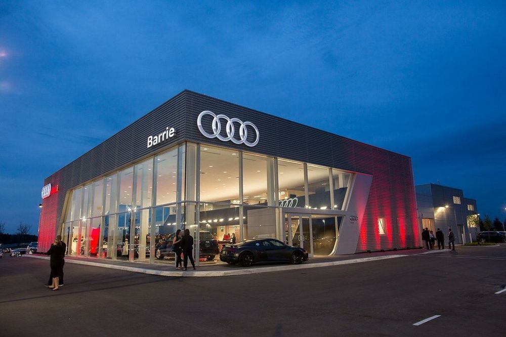 A large building with a lot of windows and a car parked in front of it.