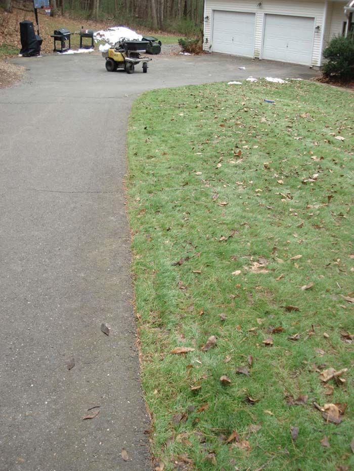 A lawn mower is parked on the side of the road